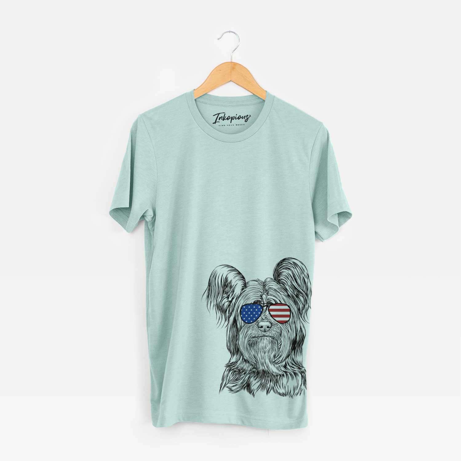 Hand-drawn sketch of Bandit the Skye Terrier wearing American flag sunglasses on a Heather Sage Unisex crewneck