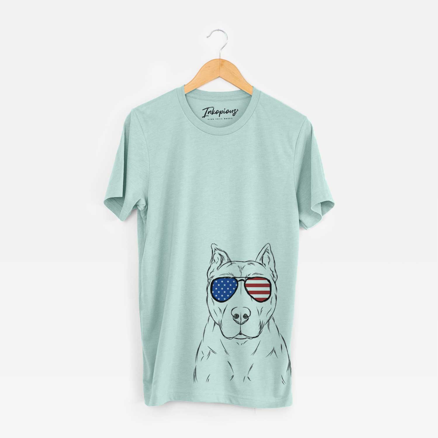 Hand-drawn sketch of Bane the Pitbull Mix wearing American flag sunglasses on a Heather Sage Unisex crewneck