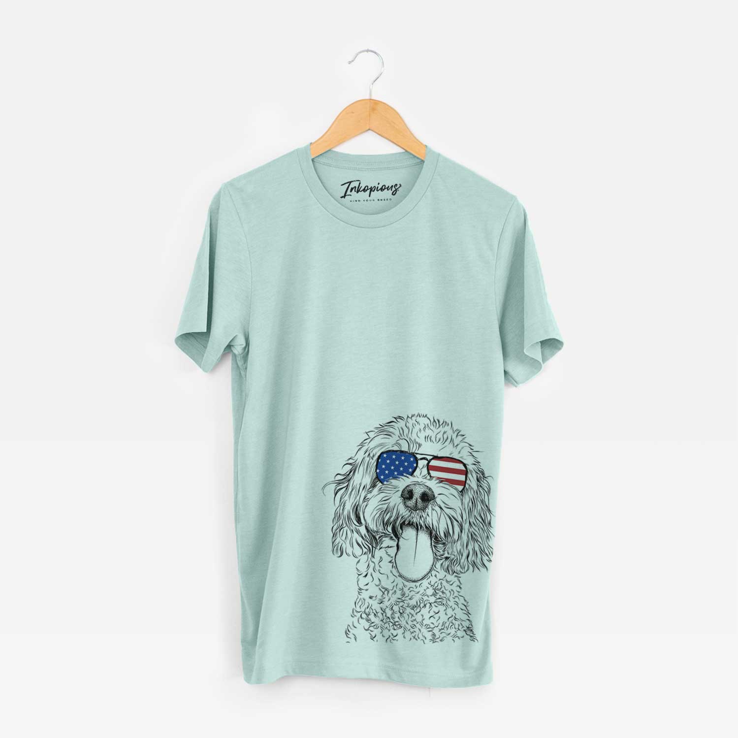 Hand-drawn sketch of Barney the Cavachon wearing American flag sunglasses on a Heather Sage Unisex crewneck