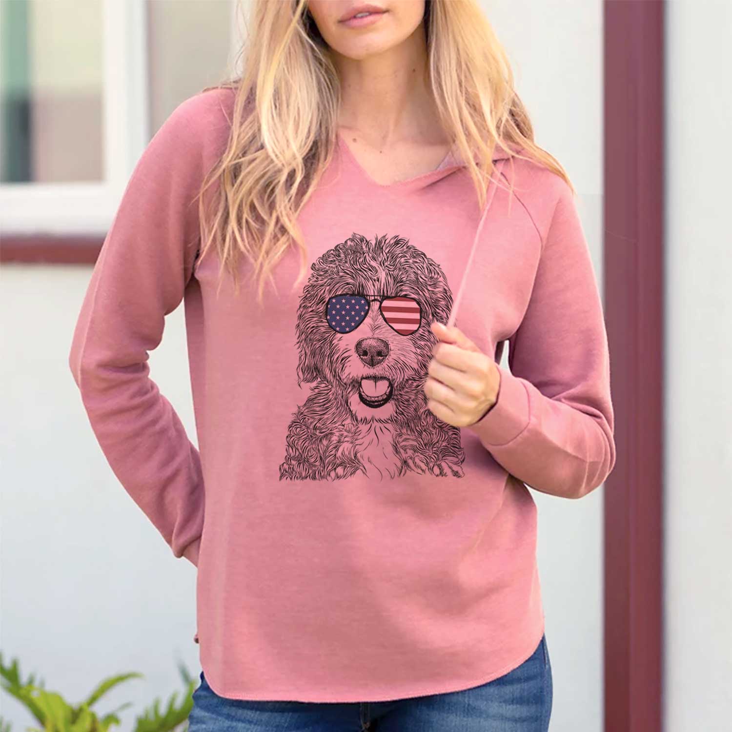 Hand-drawn sketch of Bash the Bernedoodle wearing American flag sunglasses on a Dusty Rose Cali Wave Hooded Sweatshirt, lifestyle photo