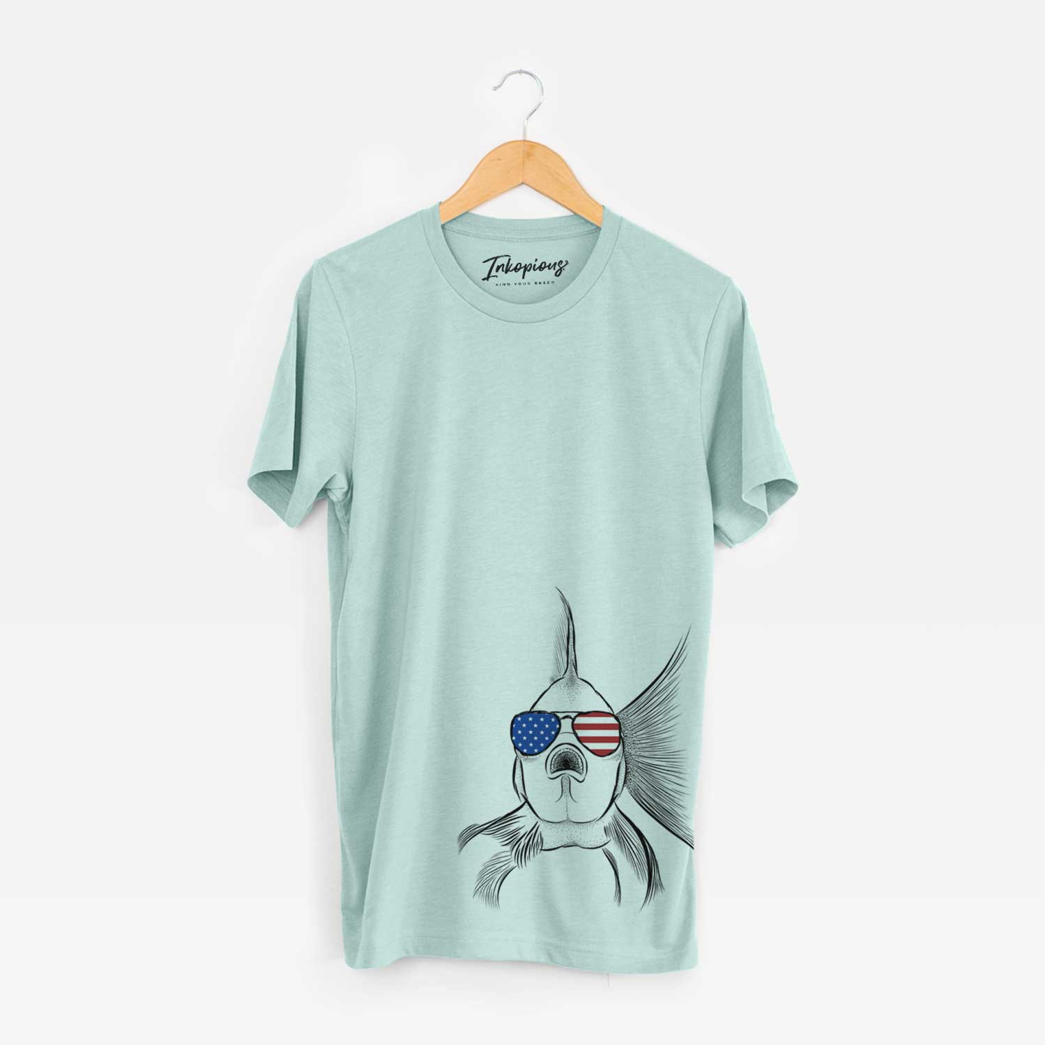 Hand-drawn sketch of Beefcake the Goldfish wearing American flag sunglasses on a Heather Sage Unisex crewneck