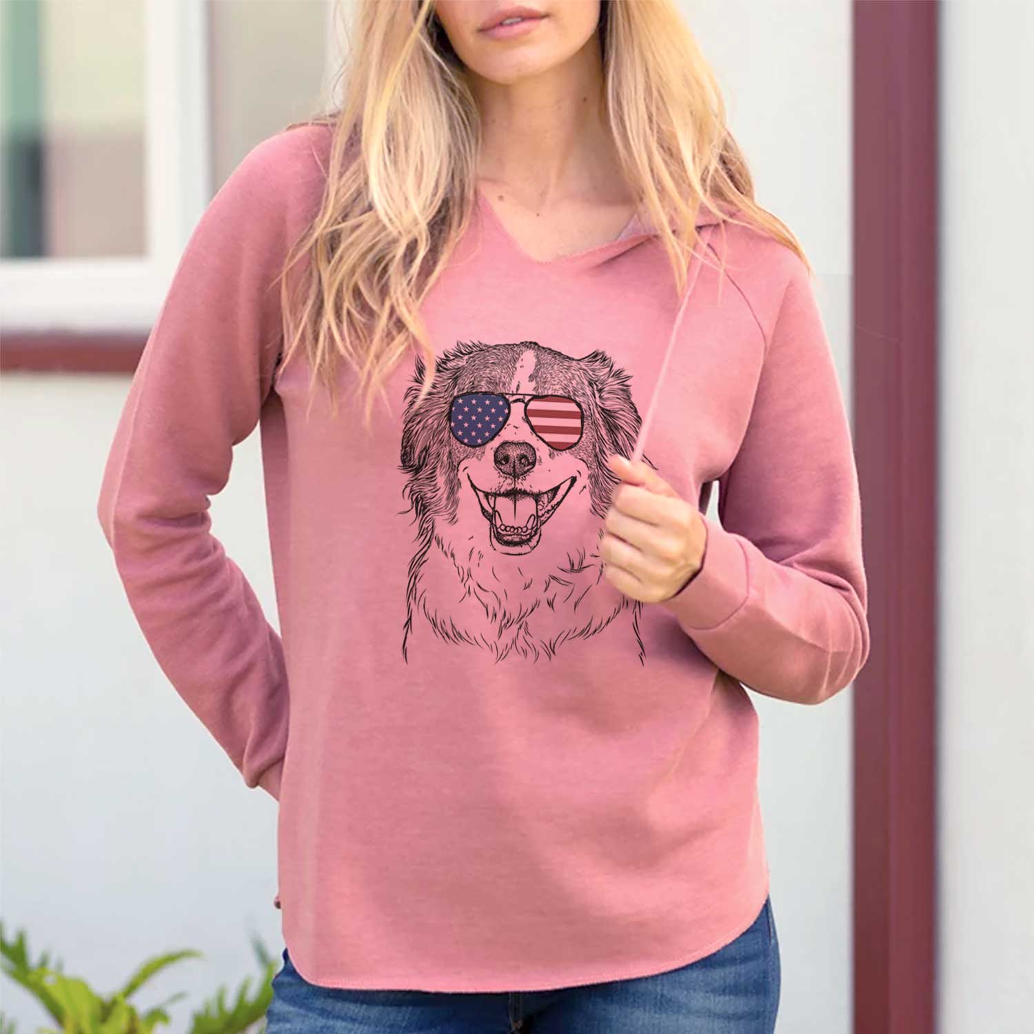 Hand-drawn sketch of Belle the Australian Shepherd Mix wearing American flag sunglasses on a Dusty Rose Cali Wave Hooded Sweatshirt, lifestyle photo