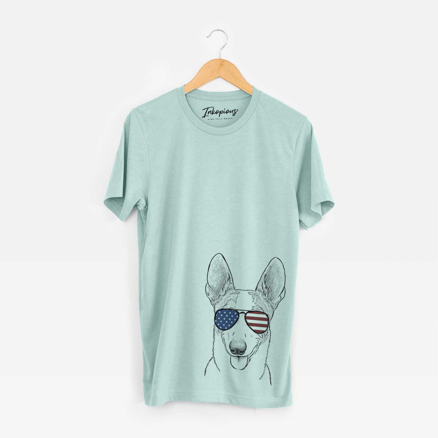Hand-drawn sketch of Berlin the Carolina Dog wearing American flag sunglasses on a Heather Sage Unisex crewneck