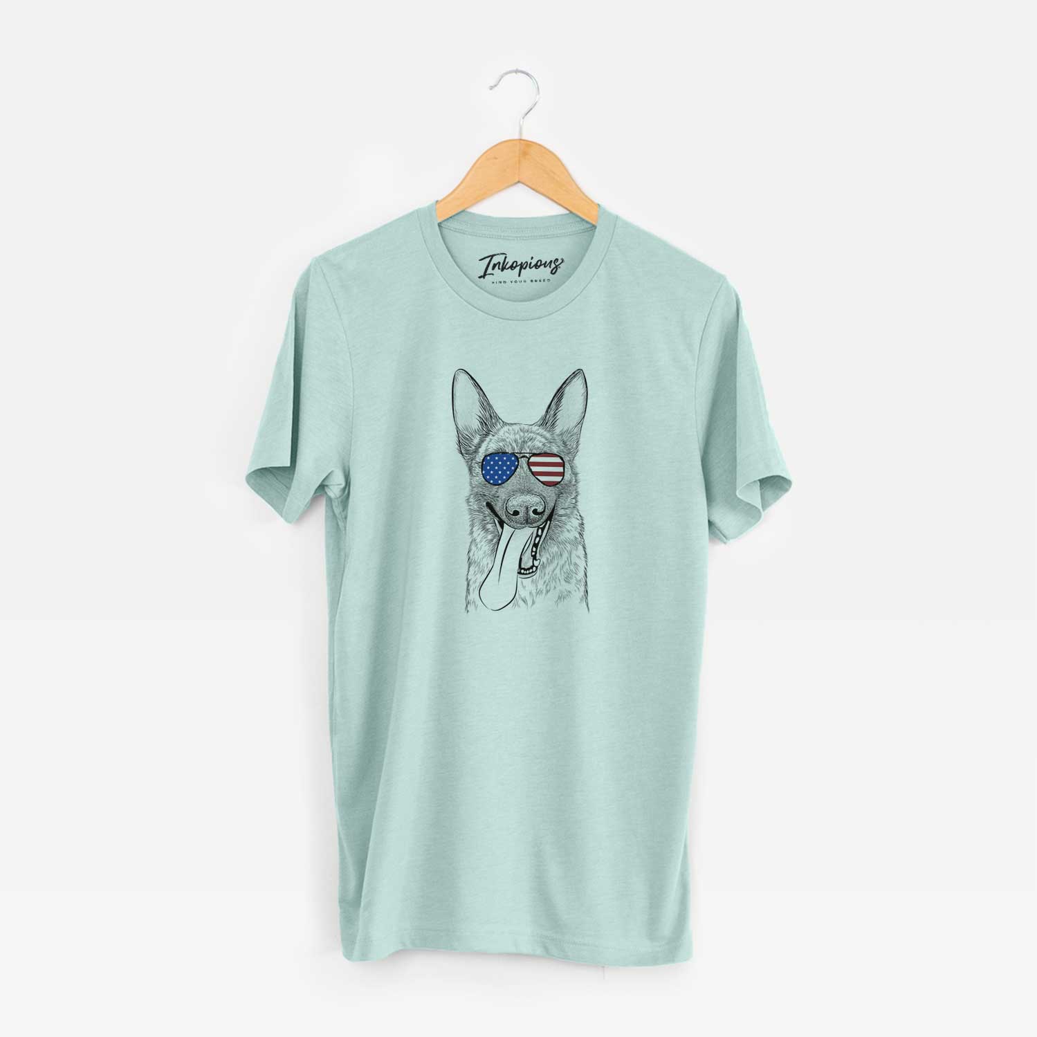 Hand-drawn sketch of Bessa the Dutch Shepherd wearing American flag sunglasses on a Heather Sage Unisex crewneck