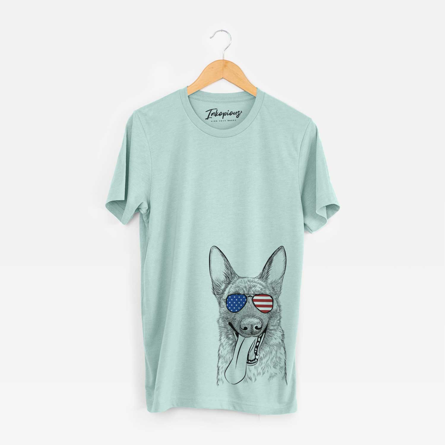 Hand-drawn sketch of Bessa the Dutch Shepherd wearing American flag sunglasses on a Heather Sage Unisex crewneck