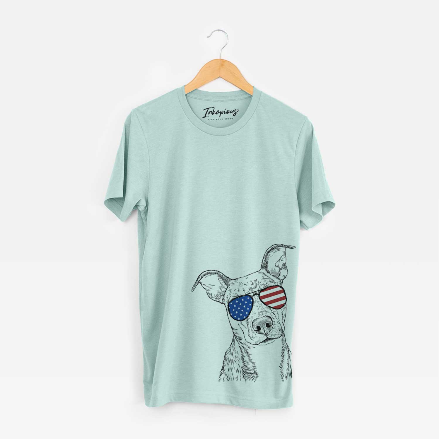 Hand-drawn sketch of Bianca the Mixed Breed wearing American flag sunglasses on a Heather Sage Unisex crewneck