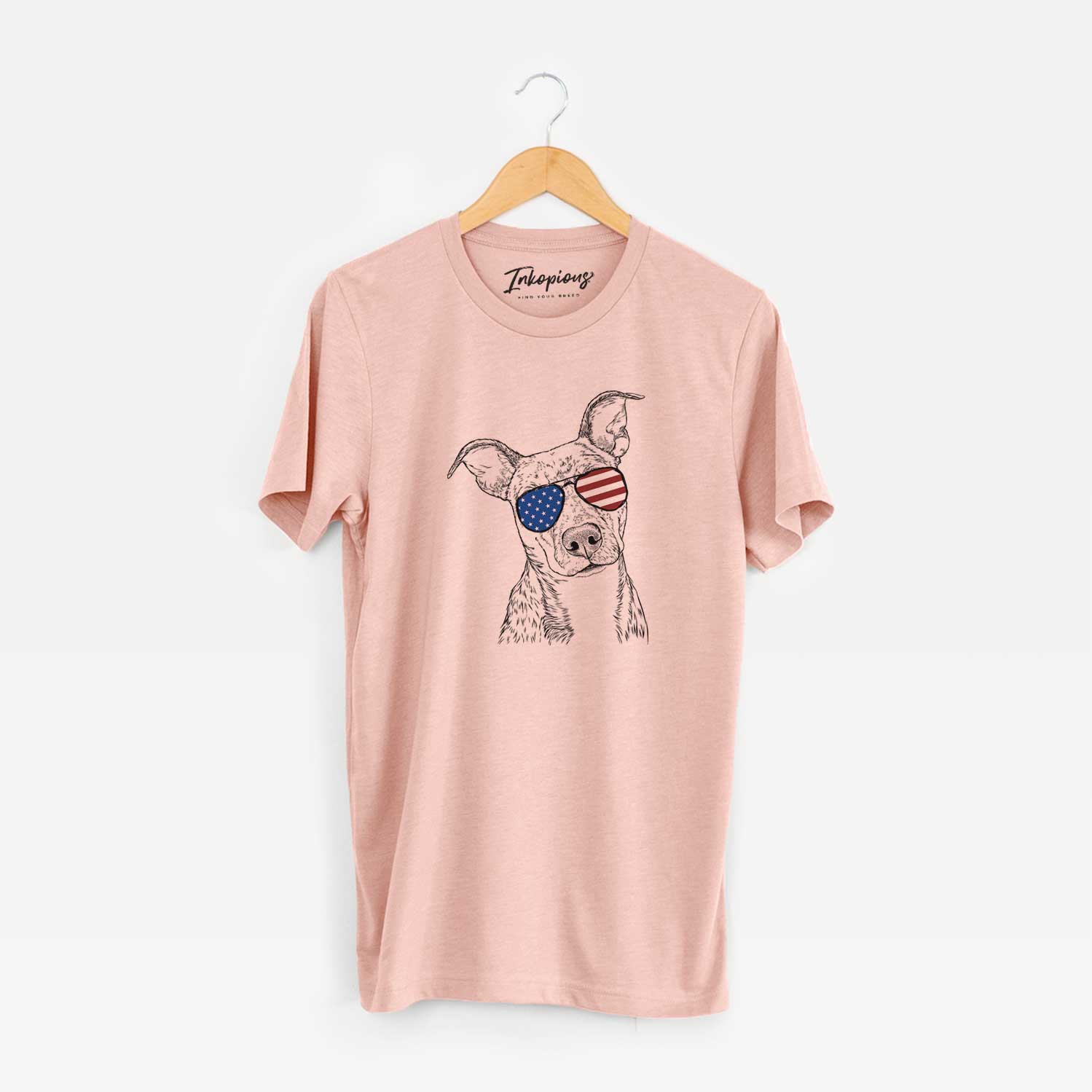 Hand-drawn sketch of Bianca the Mixed Breed wearing American flag sunglasses on a Peach Unisex crewneck