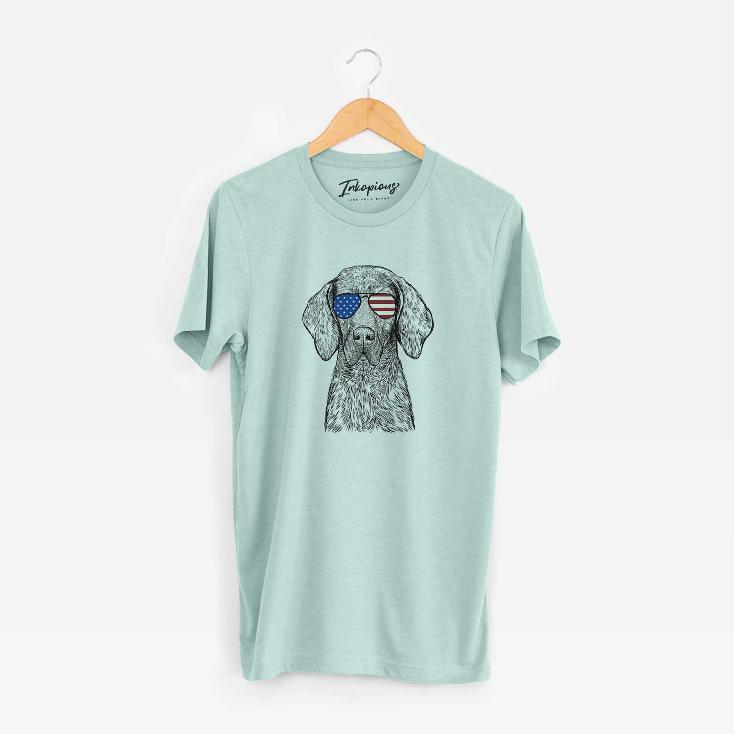 Hand-drawn sketch of Boone the Plott Hound wearing American flag sunglasses on a Heather Sage Unisex crewneck