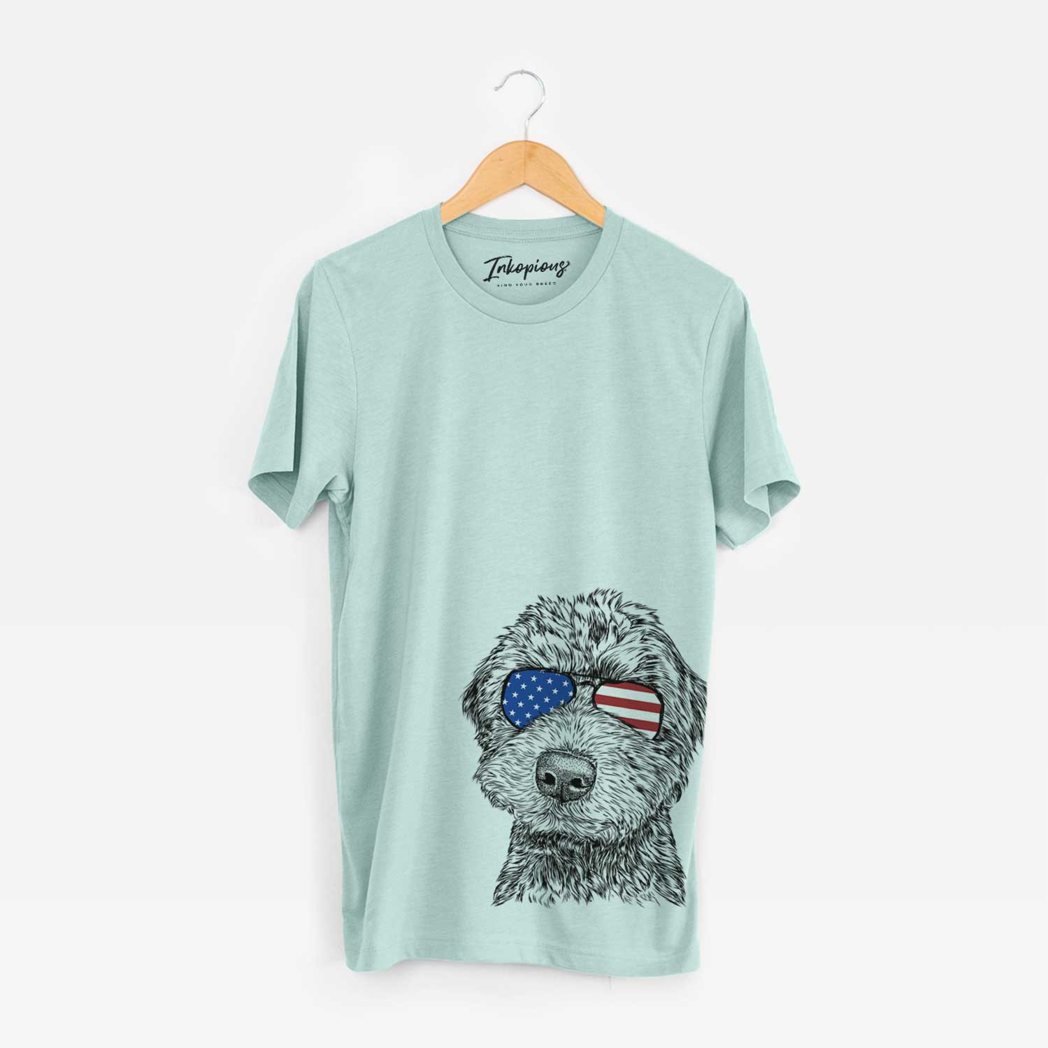 Hand-drawn sketch of Bowser the Whoodle wearing American flag sunglasses on a Heather Sage Unisex crewneck