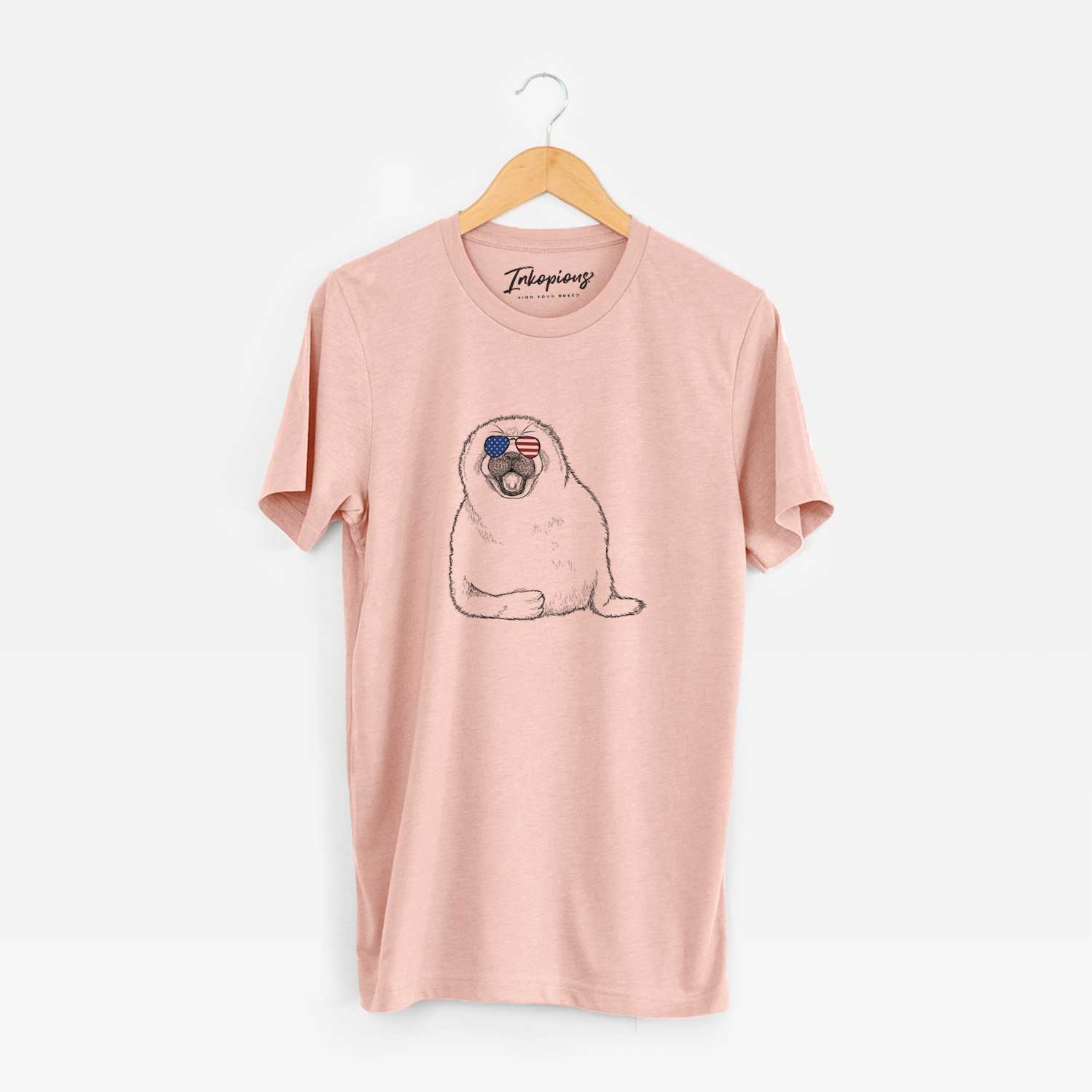 Hand-drawn sketch of Bub the Harp Seal wearing American flag sunglasses on a Peach Unisex crewneck