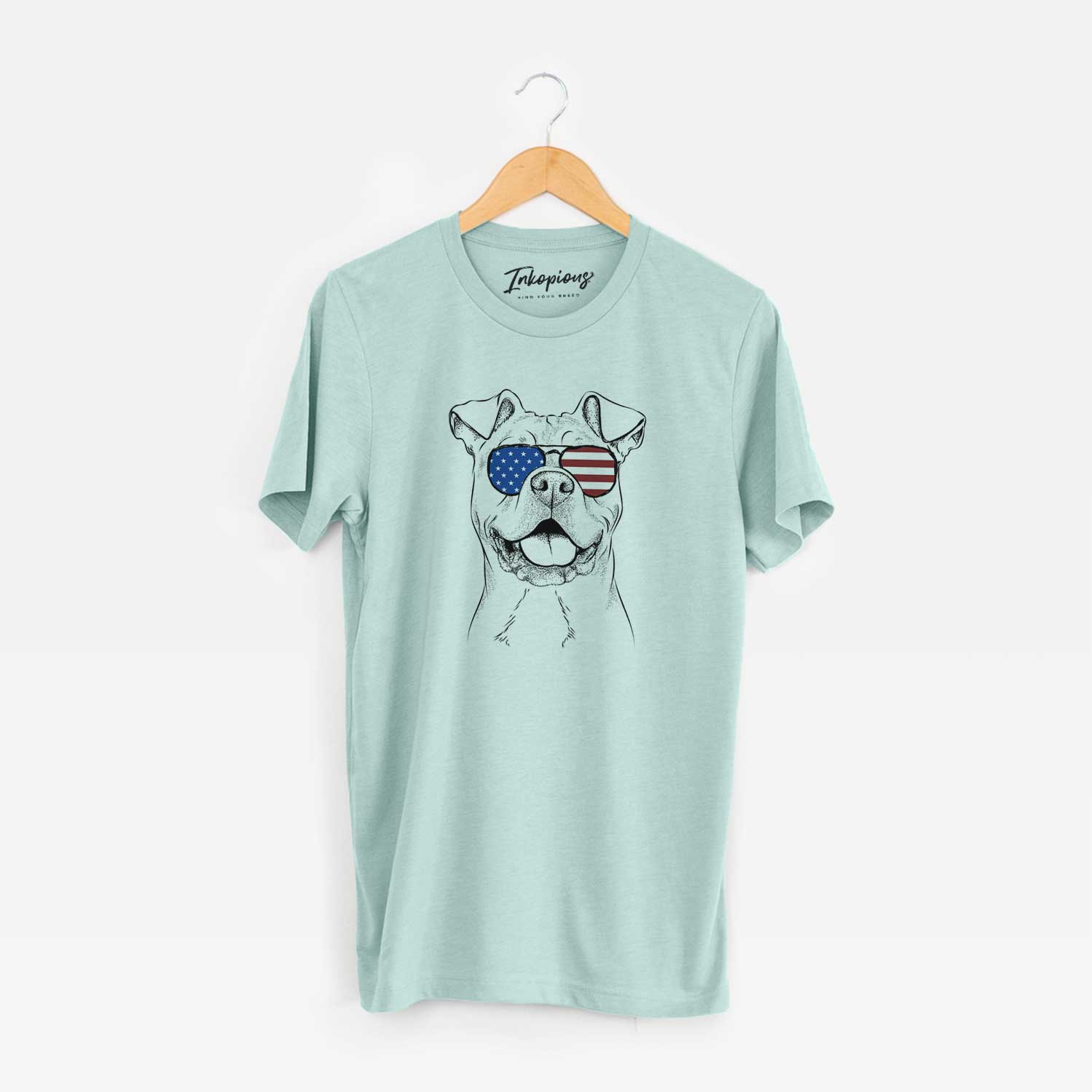 Hand-drawn sketch of Bubba Scraps the American Staffordshire Mix wearing American flag sunglasses on a Heather Sage Unisex crewneck