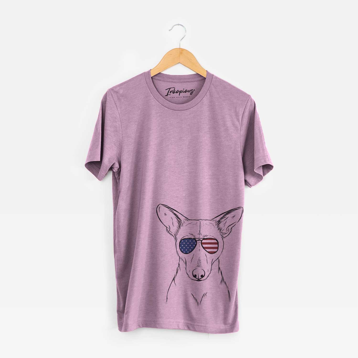 Hand-drawn sketch of Buff the Dorgi wearing American flag sunglasses on an Orchid Unisex crewneck