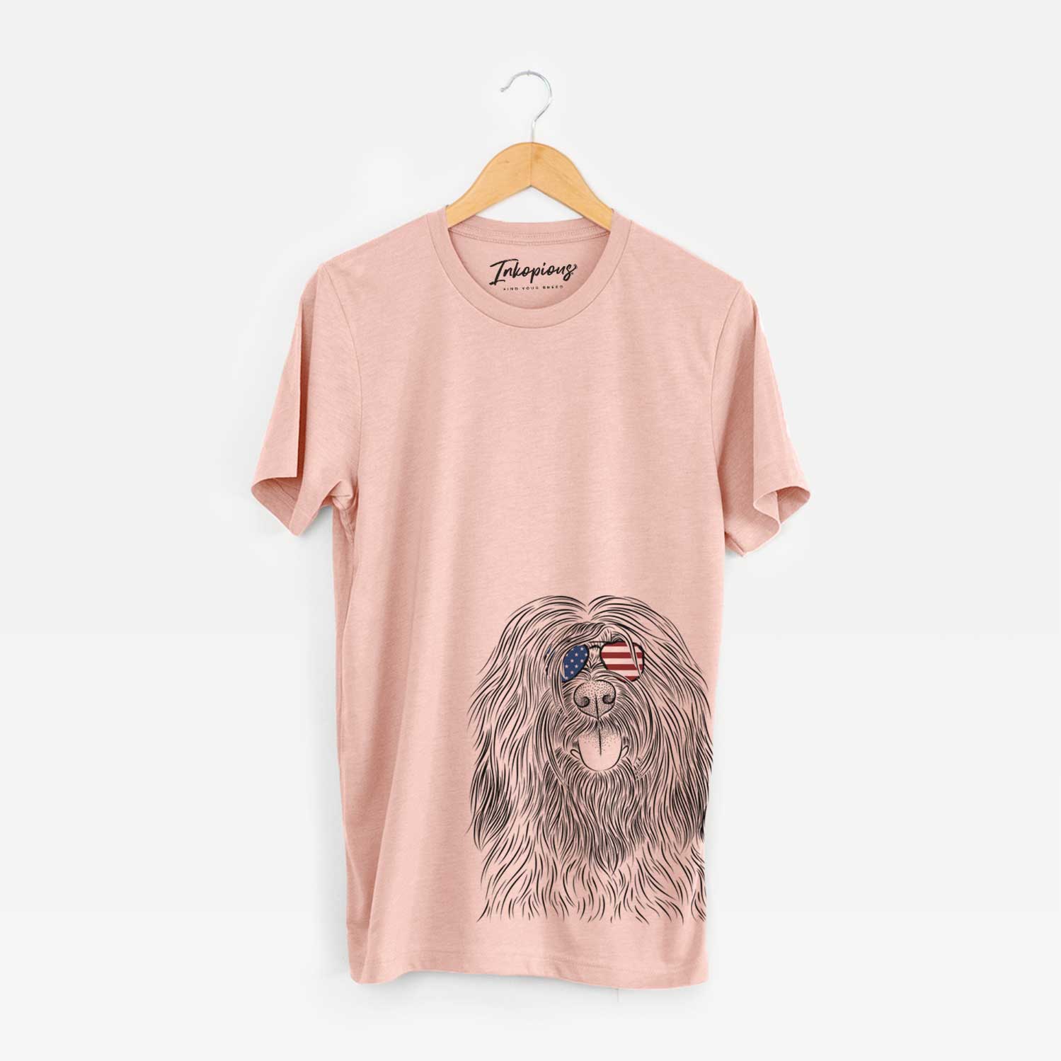 Hand-drawn sketch of Bundy the Briard wearing American flag sunglasses on a Peach Unisex crewneck