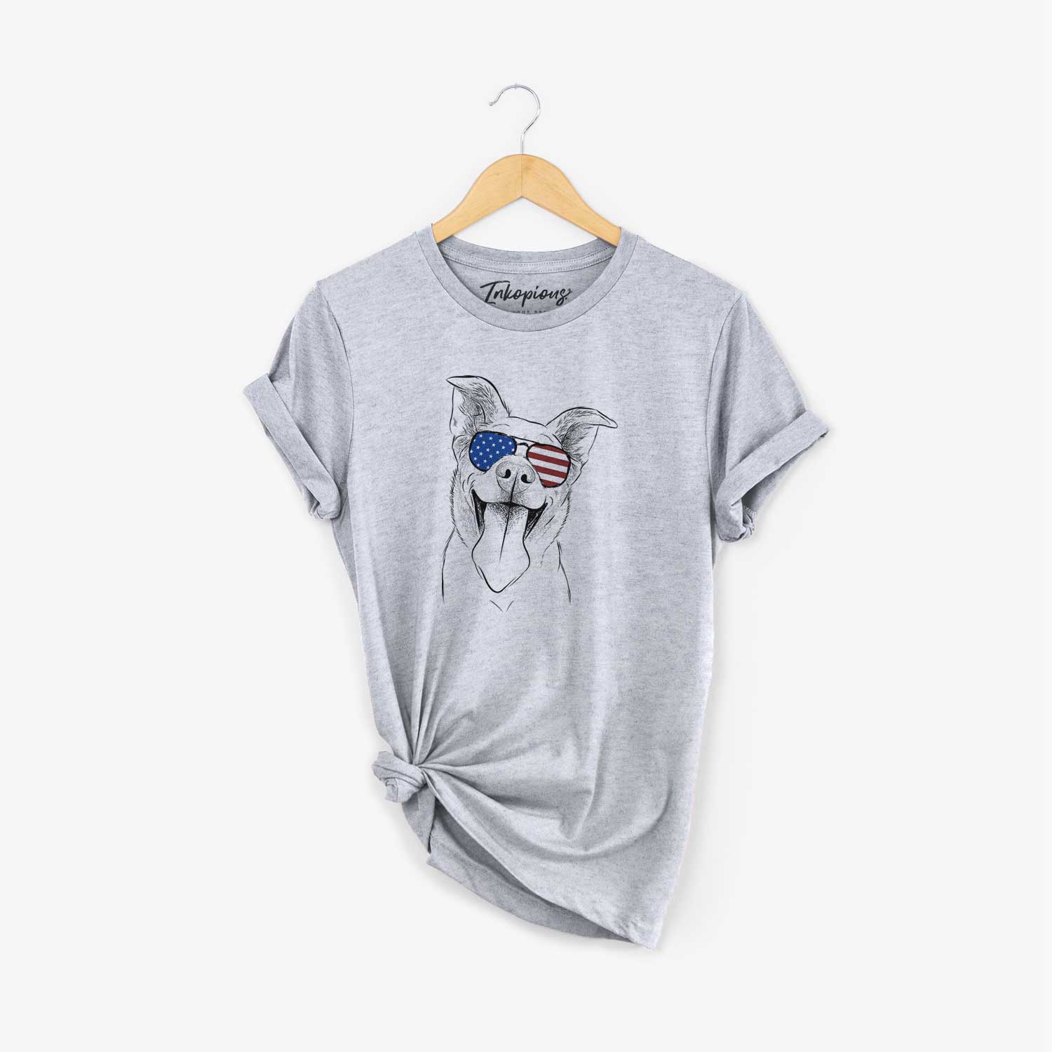 Hand-drawn sketch of Candy the Mixed Breed wearing American flag sunglasses on a Grey Unisex crewneck