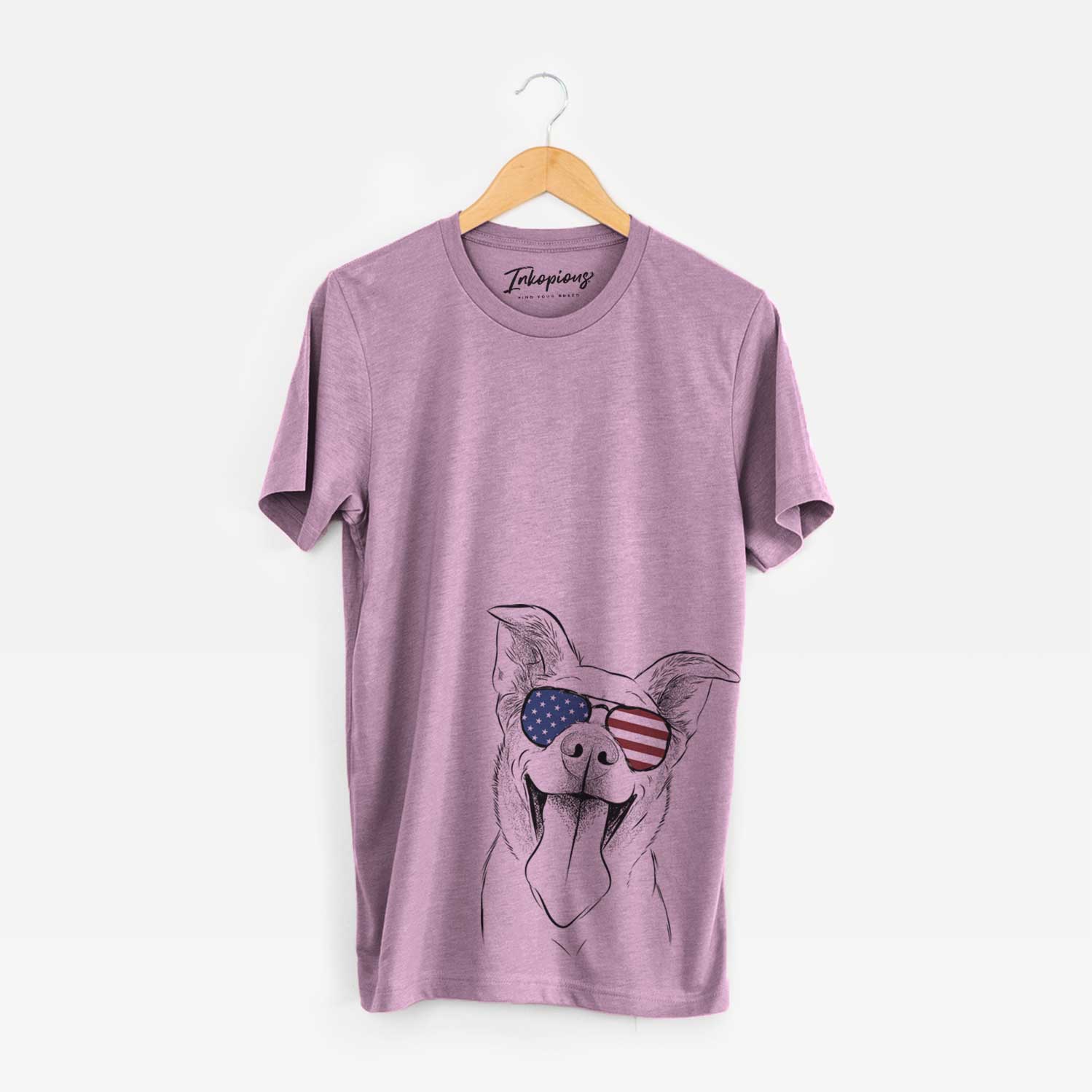 Hand-drawn sketch of Candy the Mixed Breed wearing American flag sunglasses on an Orchid Unisex crewneck