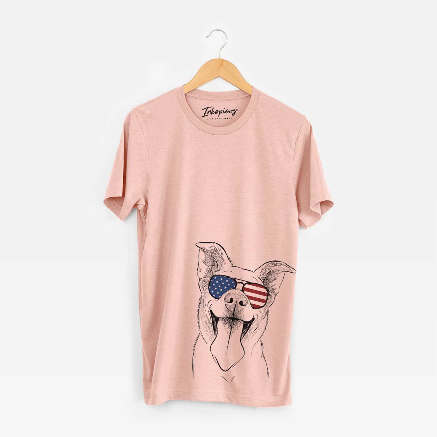Hand-drawn sketch of Candy the Mixed Breed wearing American flag sunglasses on a Peach Unisex crewneck