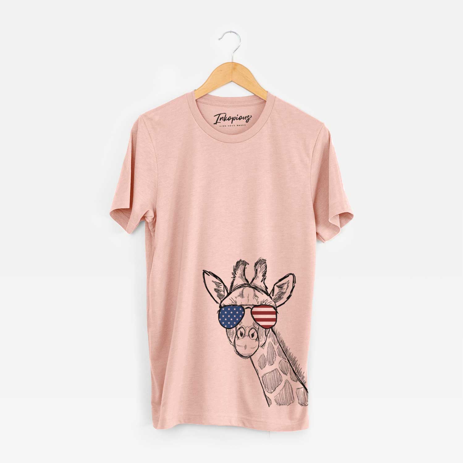 Hand-drawn sketch of Cedrick the Giraffe wearing American flag sunglasses on a Peach Unisex crewneck