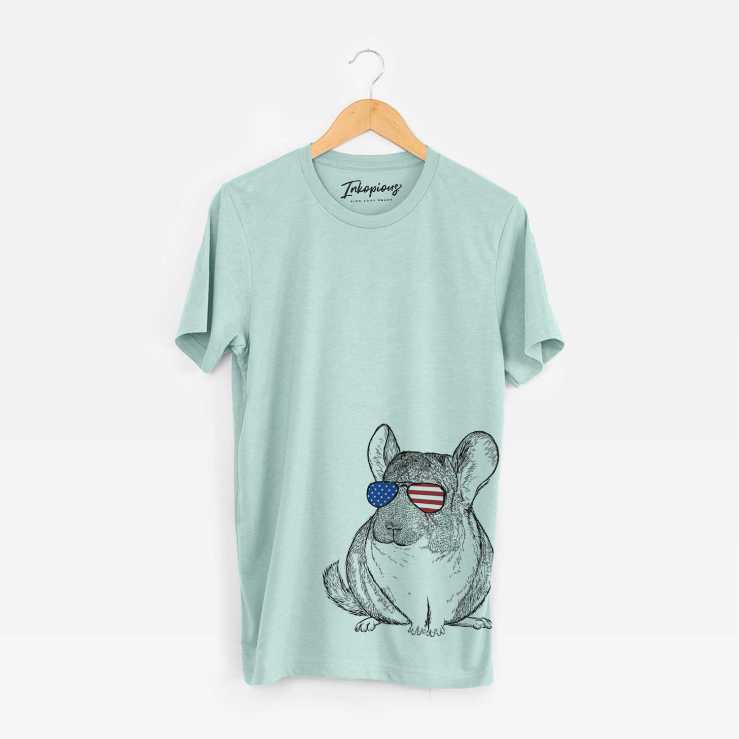 Hand-drawn sketch of Cheddar the Chinchilla wearing American flag sunglasses on a Heather Sage Unisex crewneck