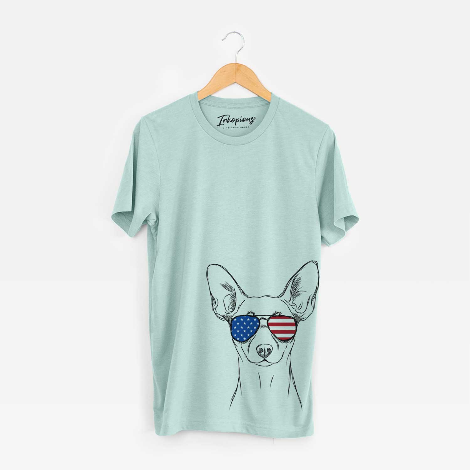 Hand-drawn sketch of Chillie the Mini Pinscher wearing American flag sunglasses on a Heather Sage Unisex crewneck