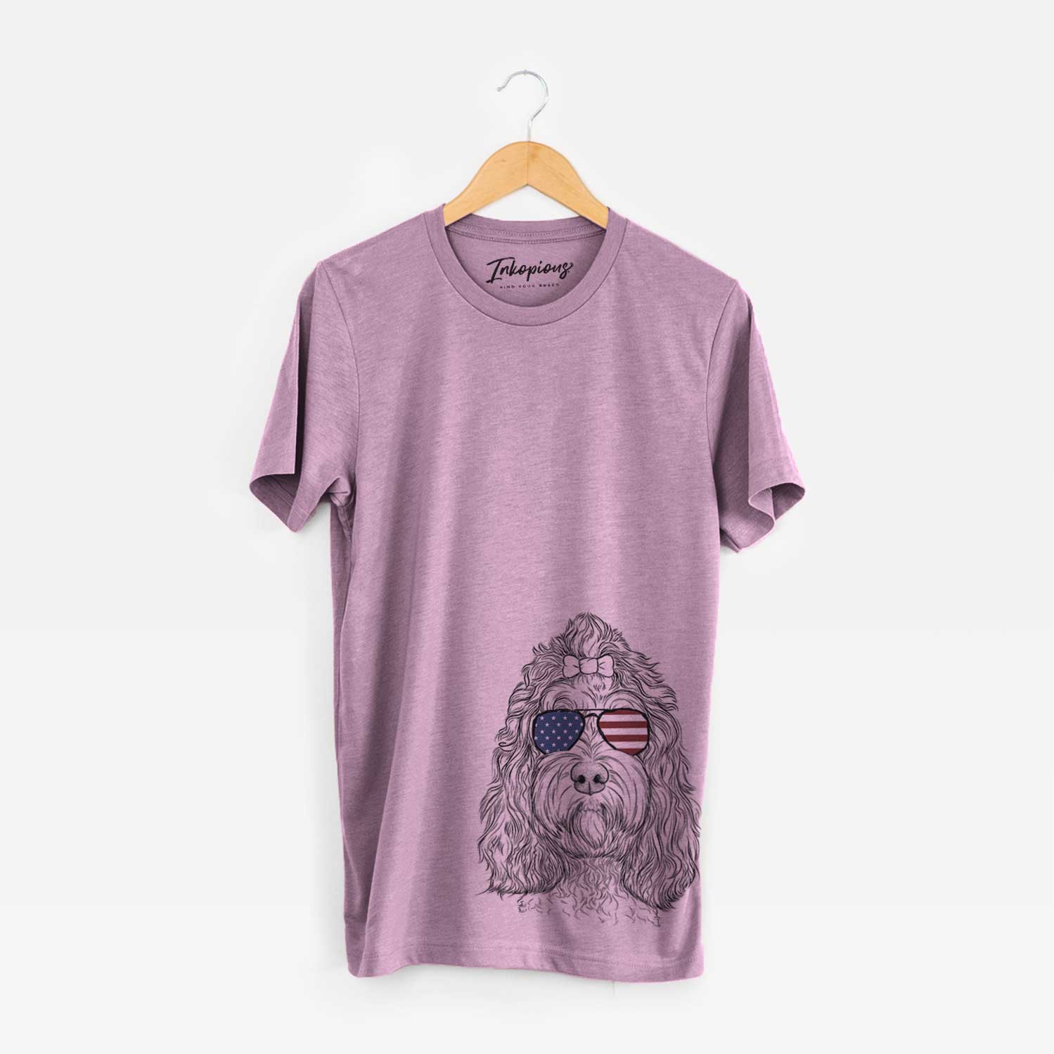 Hand-drawn sketch of Chloe the Cockapoo wearing American flag sunglasses on an Orchid Unisex crewneck