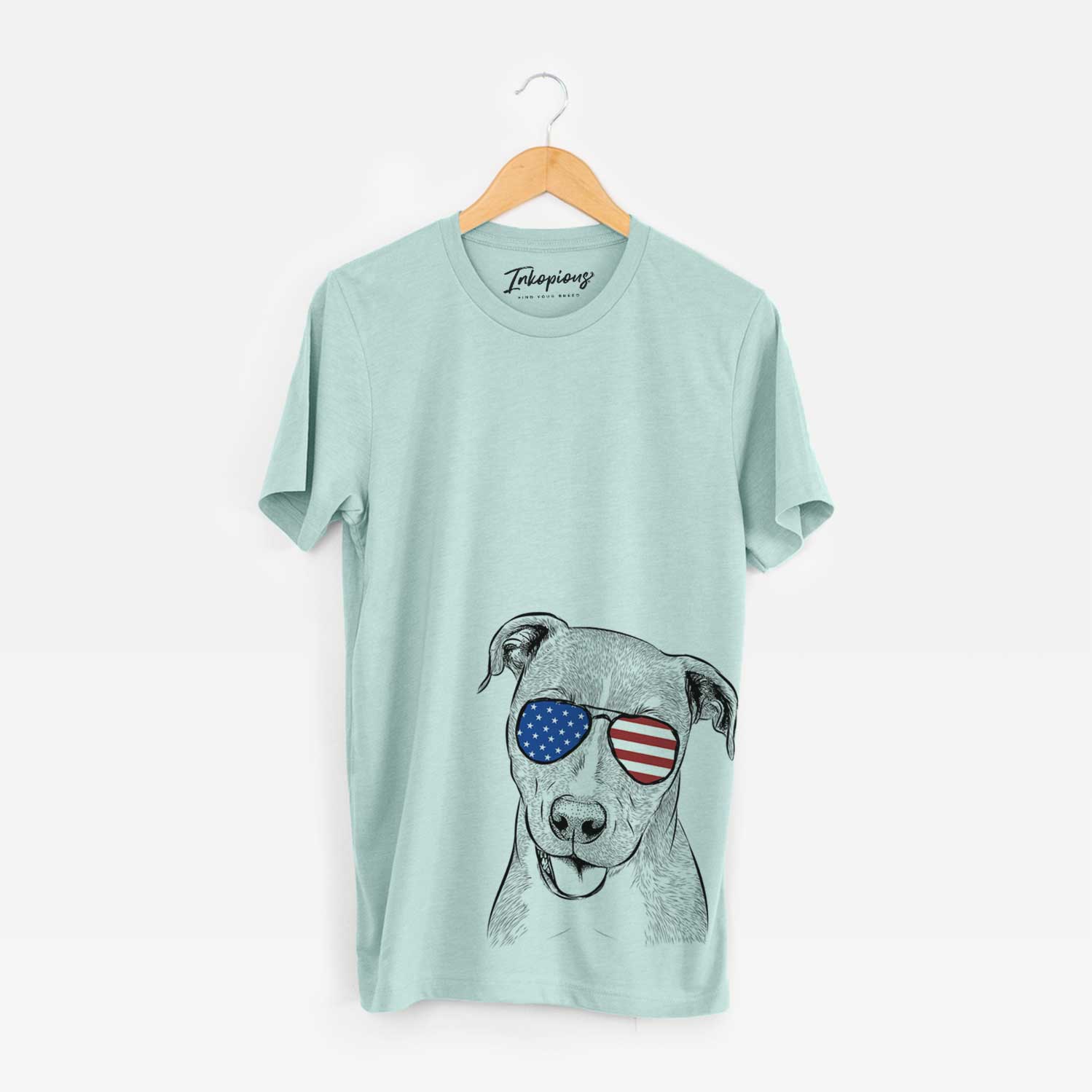 Hand-drawn sketch of Claiborne the American Staffordshire Terrier wearing American flag sunglasses on a Heather Sage Unisex crewneck
