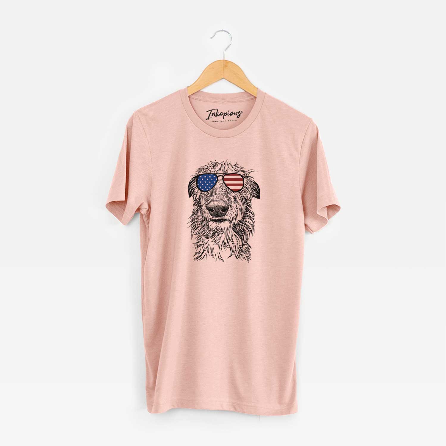 Hand-drawn sketch of Cleod the Scottish Deerhound wearing American flag sunglasses on a Peach Unisex crewneck