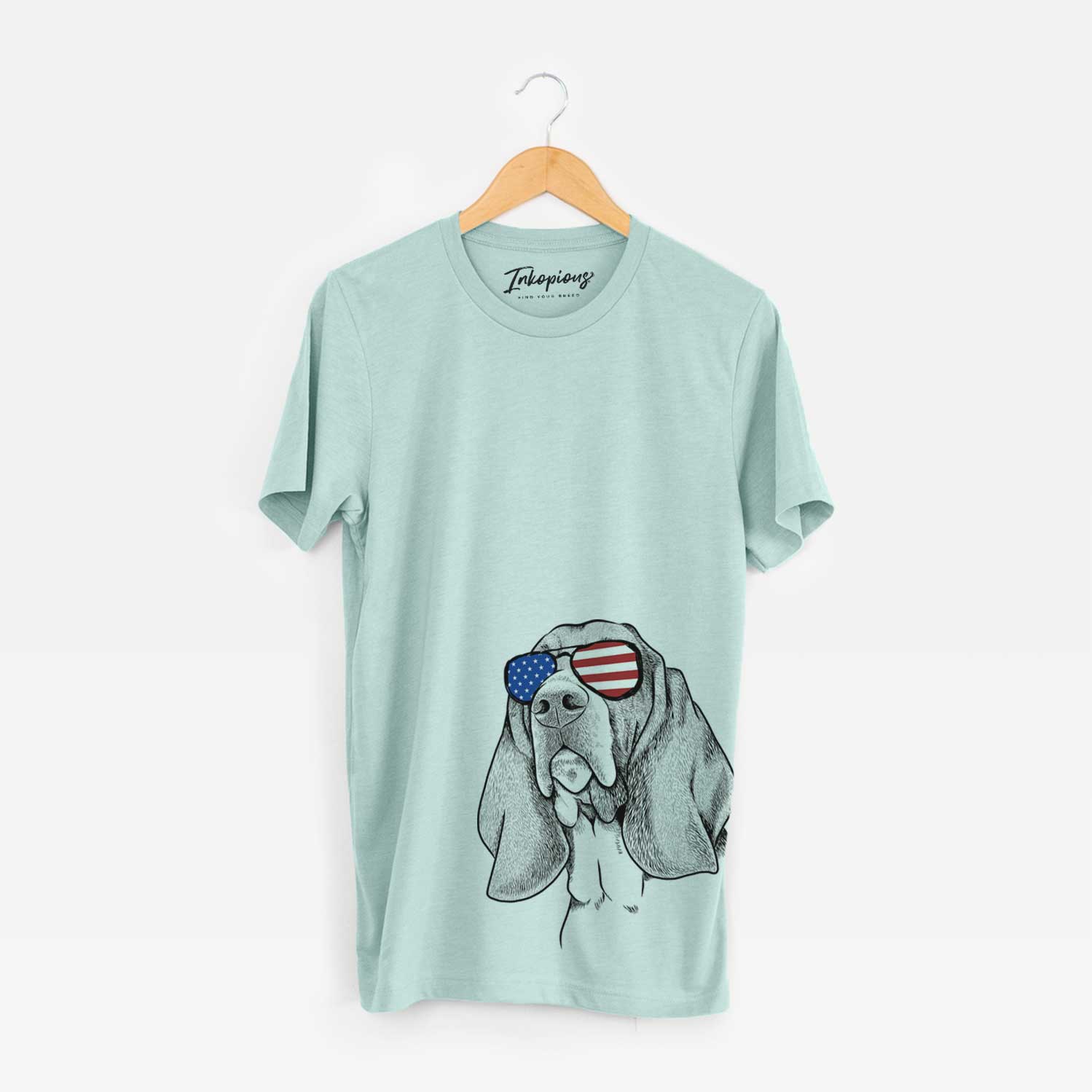 Hand-drawn sketch of Cooper the Basset Hound wearing American flag sunglasses on a Heather Sage Unisex crewneck