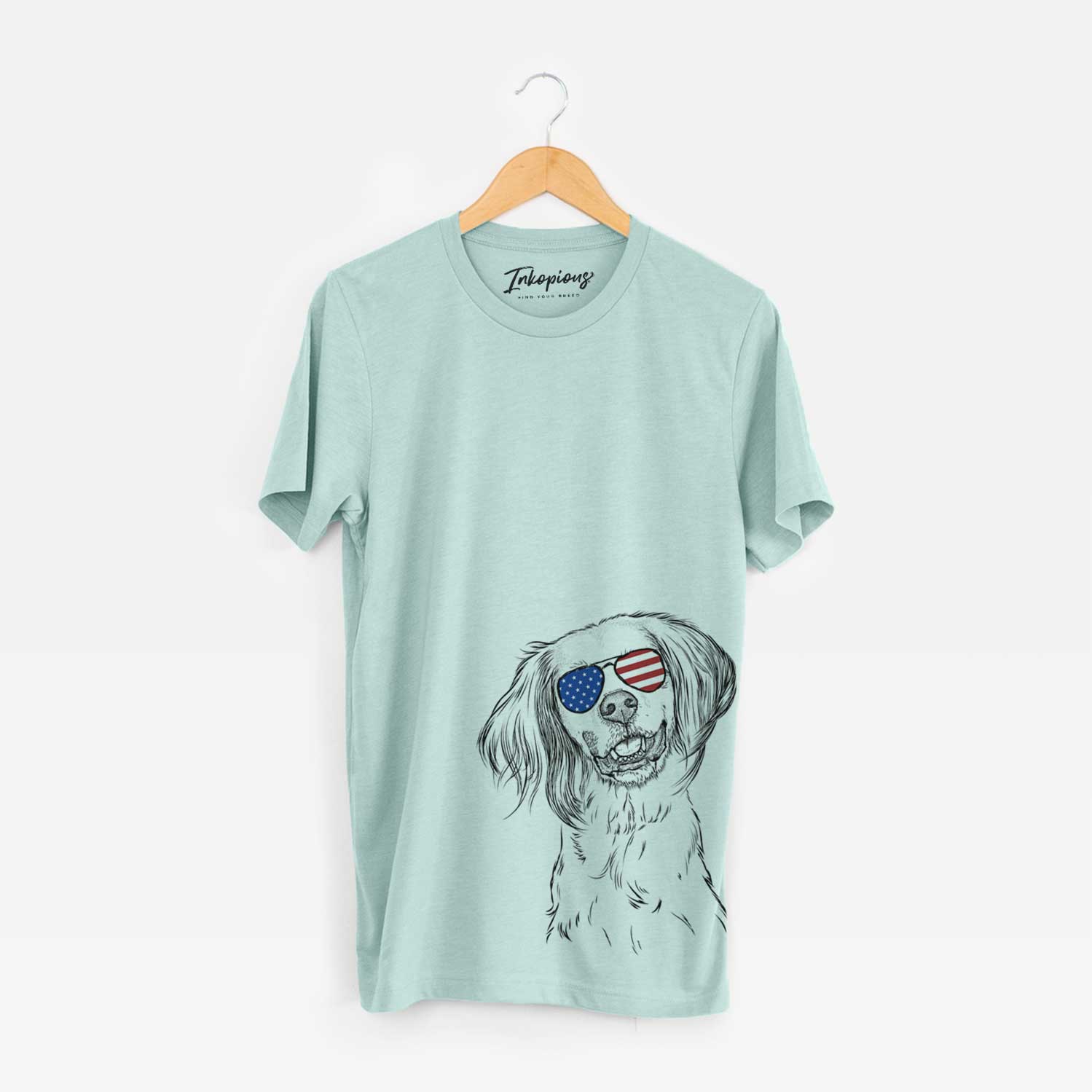 Hand-drawn sketch of Cooper the English Setter wearing American flag sunglasses on a Heather Sage Unisex crewneck