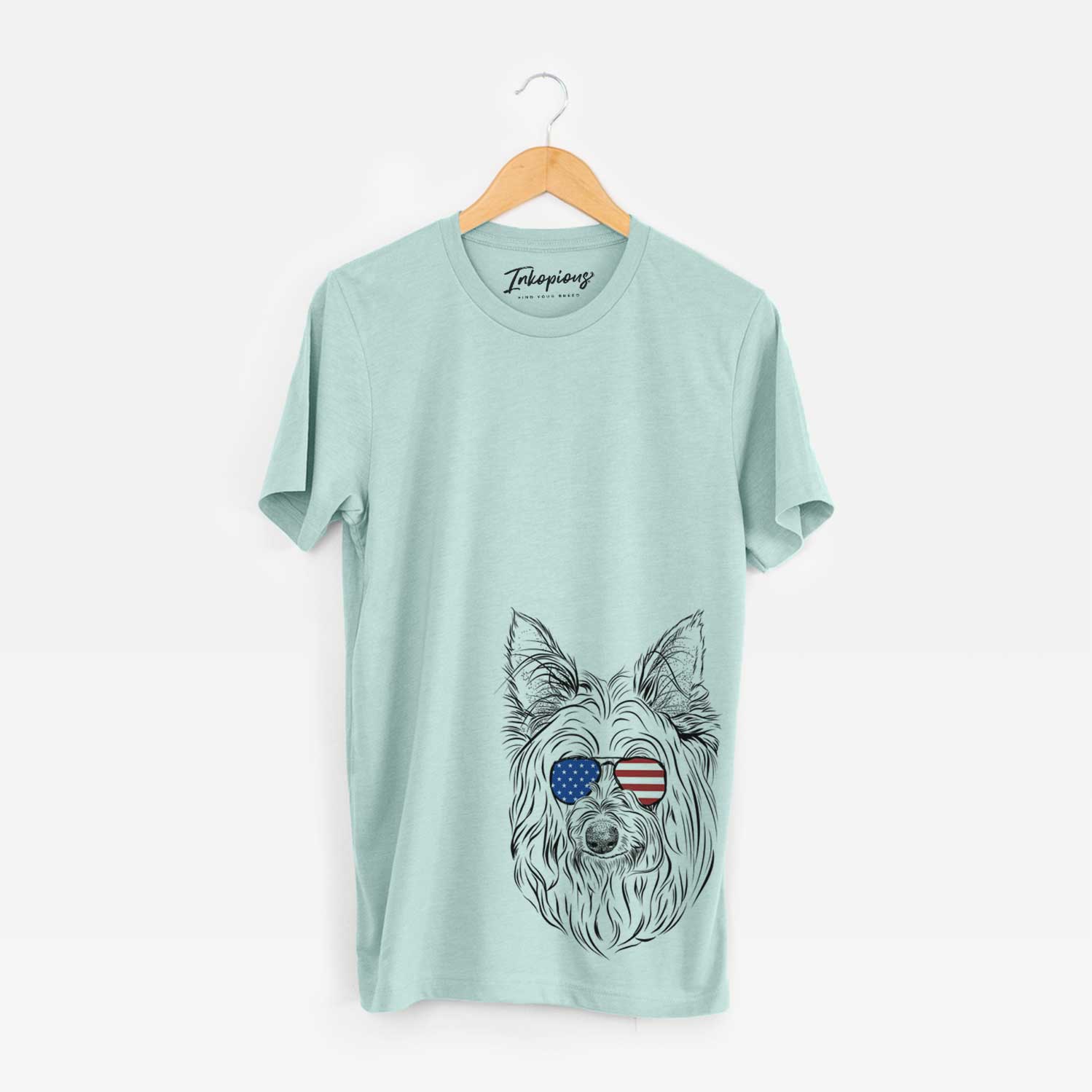 Hand-drawn sketch of Daisy May the Silky Terrier wearing American flag sunglasses on a Heather Sage Unisex crewneck