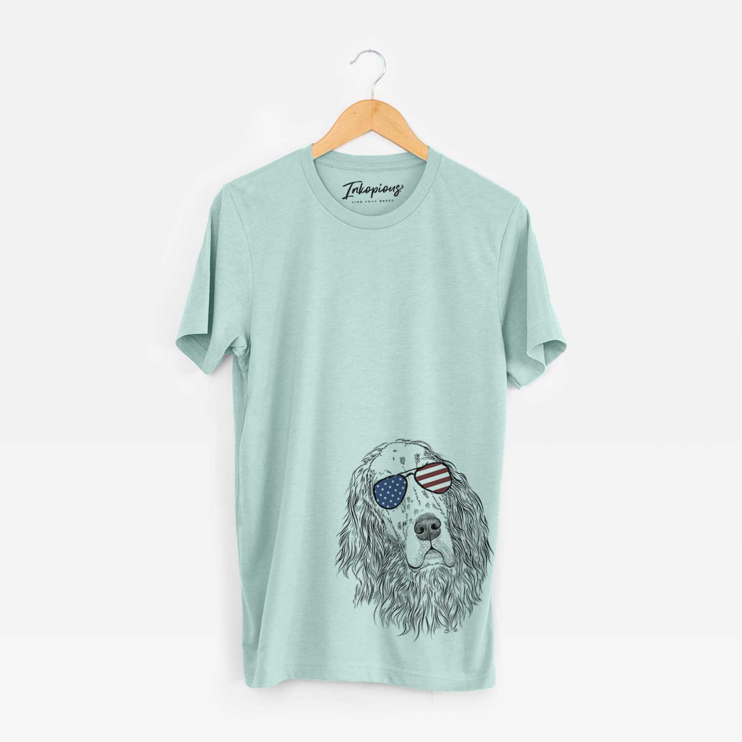 Hand-drawn sketch of Dexter the English Setter wearing American flag sunglasses on a Heather Sage Unisex crewneck