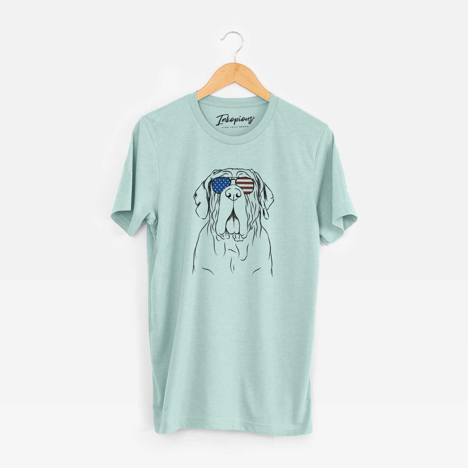 Hand-drawn sketch of Dinah the Neapolitan Mastiff wearing American flag sunglasses on a Heather Sage Unisex crewneck