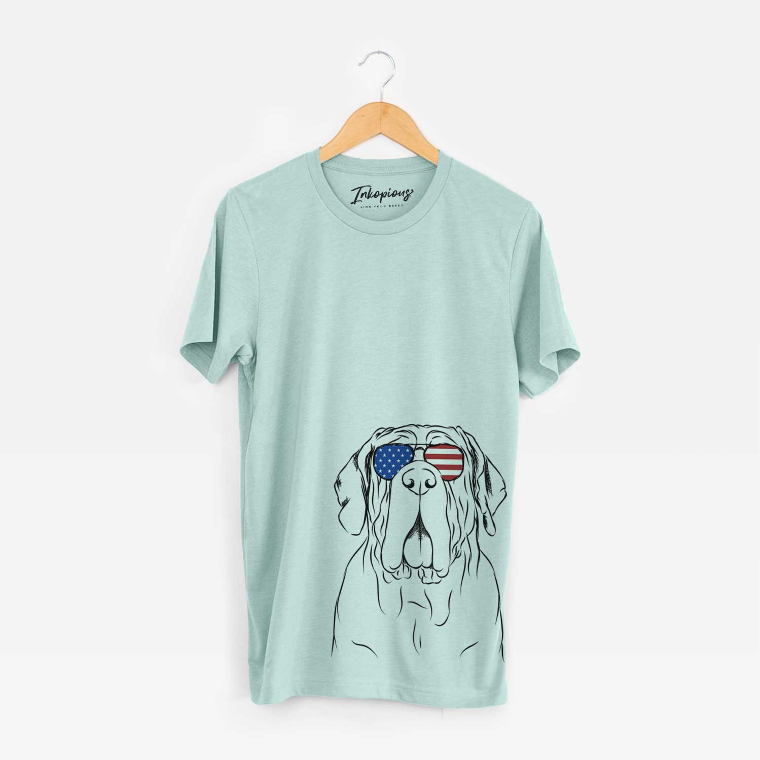 Hand-drawn sketch of Dinah the Neapolitan Mastiff wearing American flag sunglasses on a Heather Sage Unisex crewneck