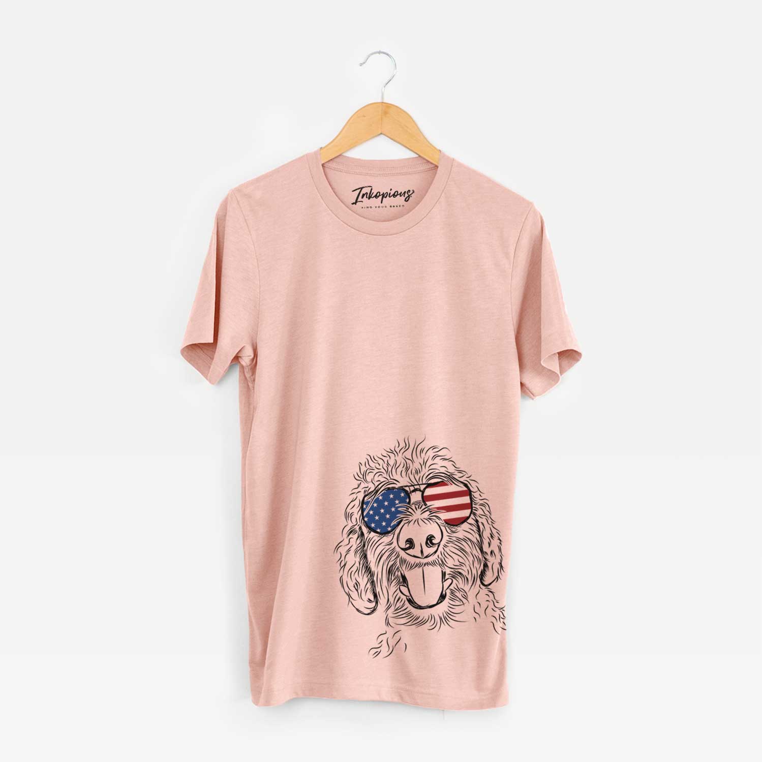 Hand-drawn sketch of Dixie the Doodle wearing American flag sunglasses on a Peach Unisex crewneck