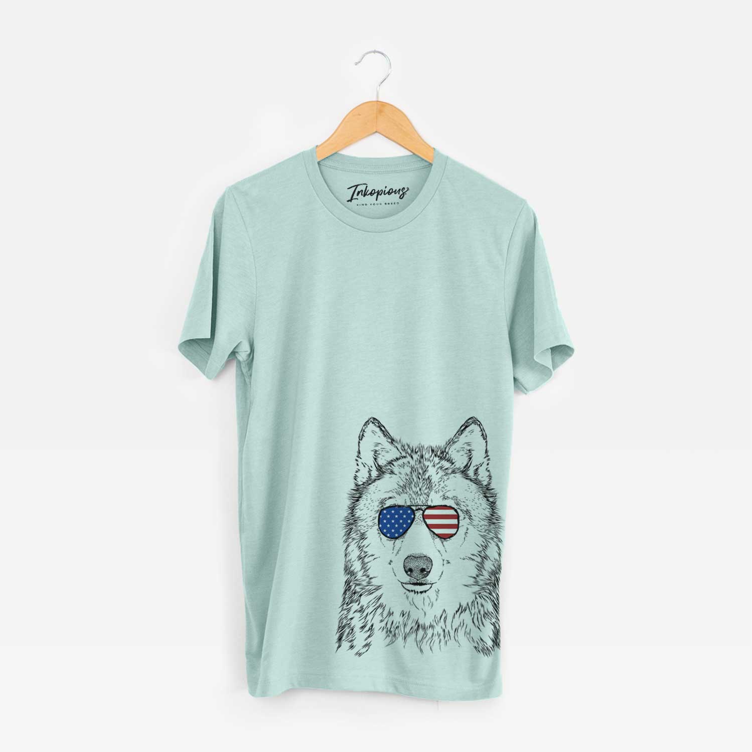 Hand-drawn sketch of Django the Grey Wolf wearing American flag sunglasses on a Heather Sage Unisex crewneck