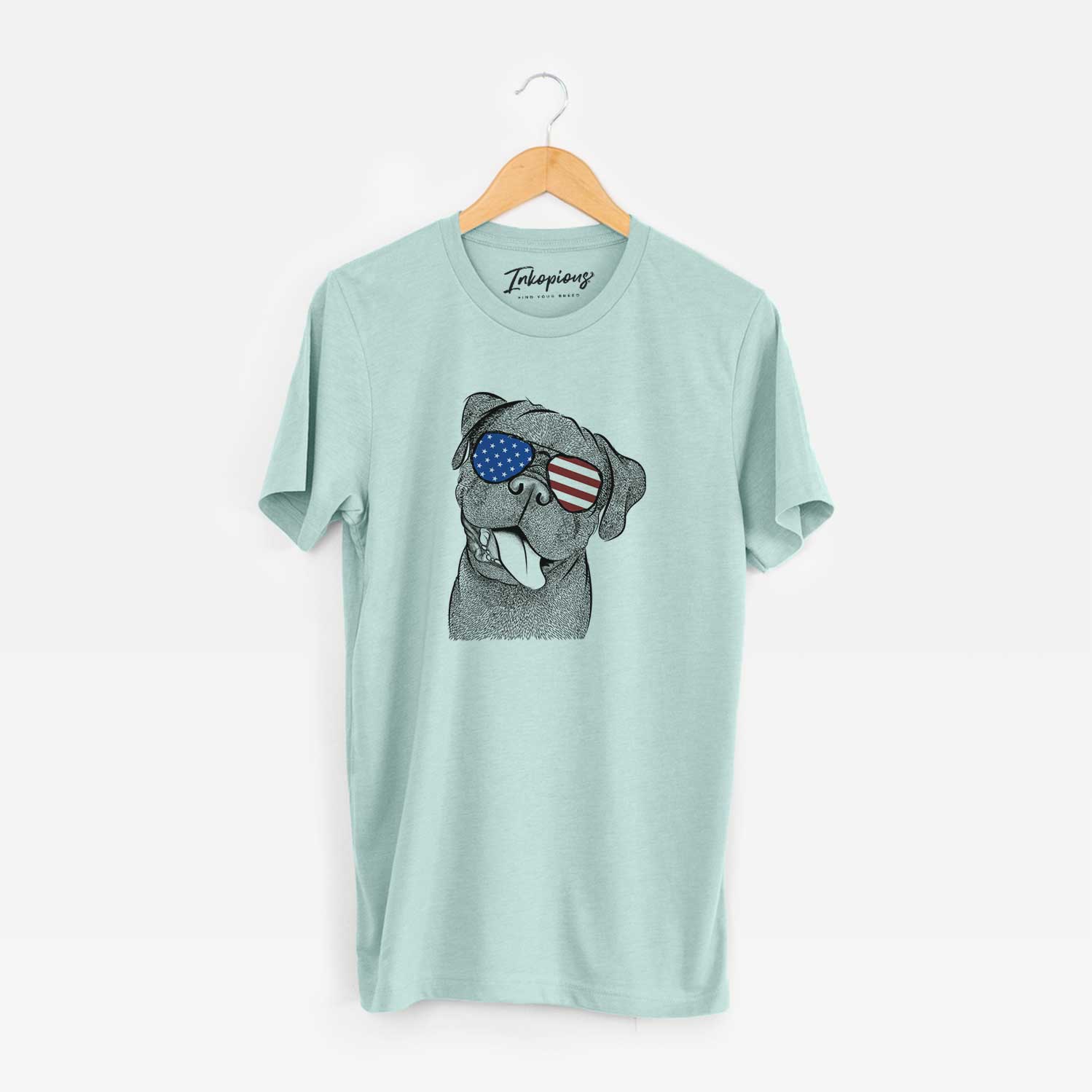 Hand-drawn sketch of Dudley Danger the Pug wearing American flag sunglasses on a Heather Sage Unisex crewneck