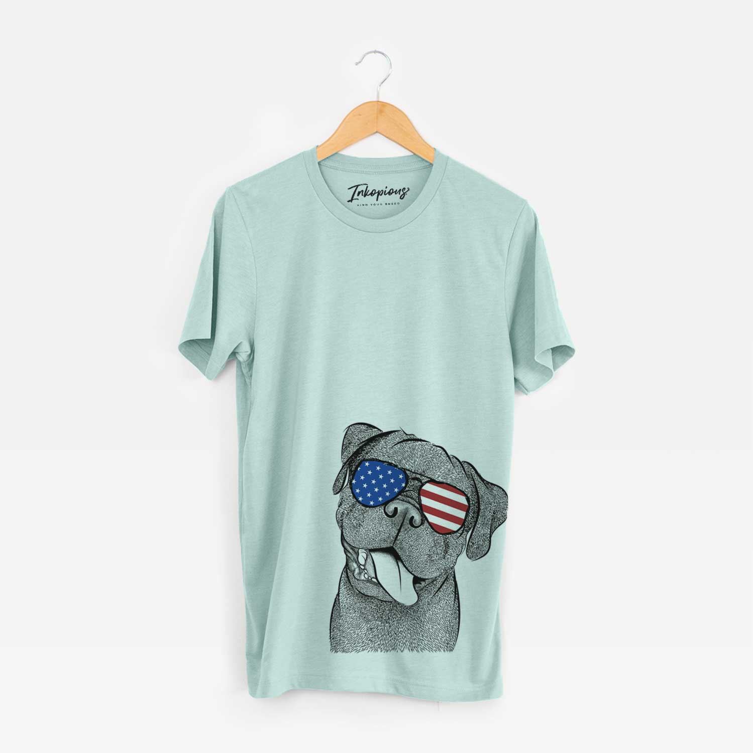 Hand-drawn sketch of Dudley Danger the Pug wearing American flag sunglasses on a Heather Sage Unisex crewneck