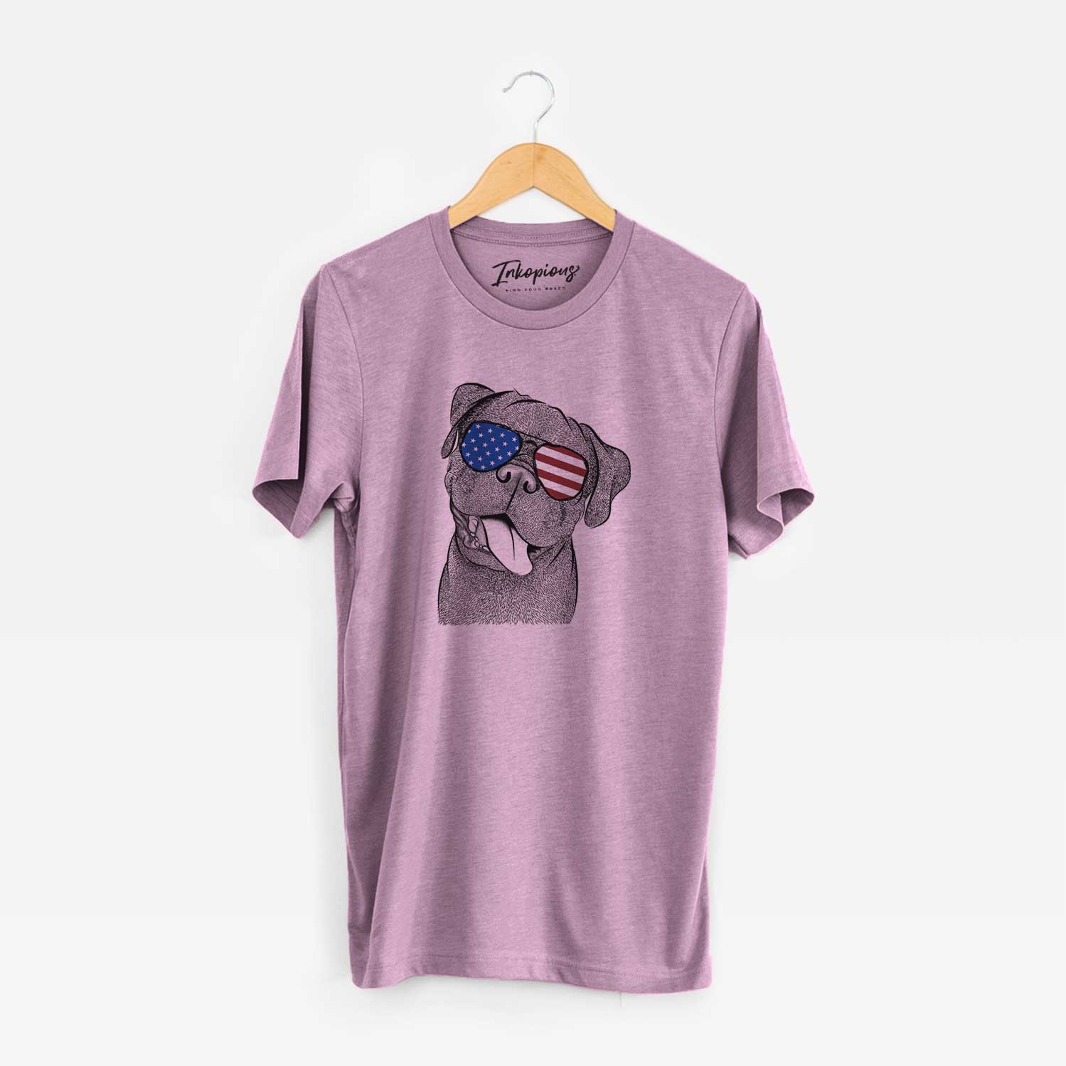 Hand-drawn sketch of Dudley Danger the Pug wearing American flag sunglasses on an Orchid Unisex crewneck