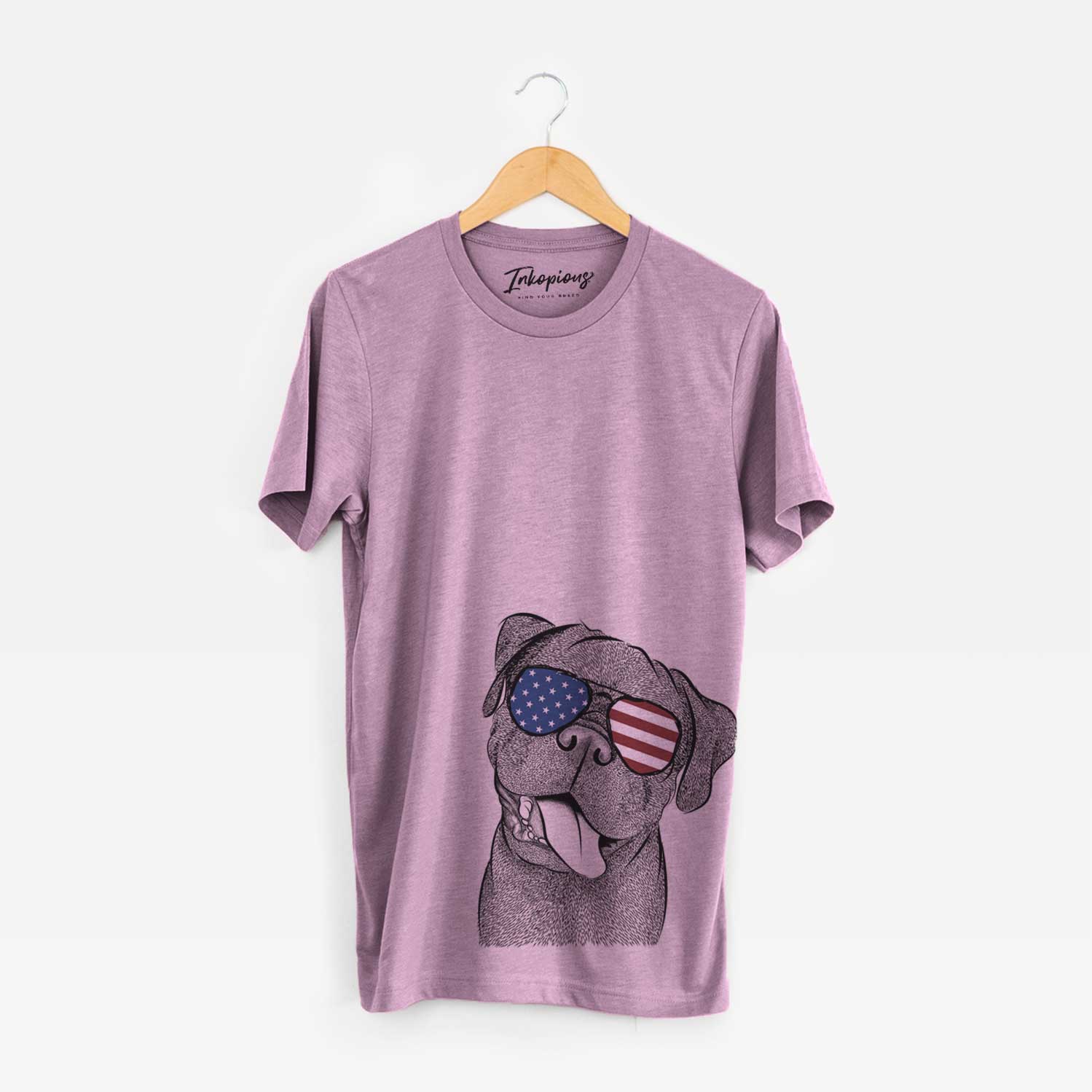 Hand-drawn sketch of Dudley Danger the Pug wearing American flag sunglasses on an Orchid Unisex crewneck
