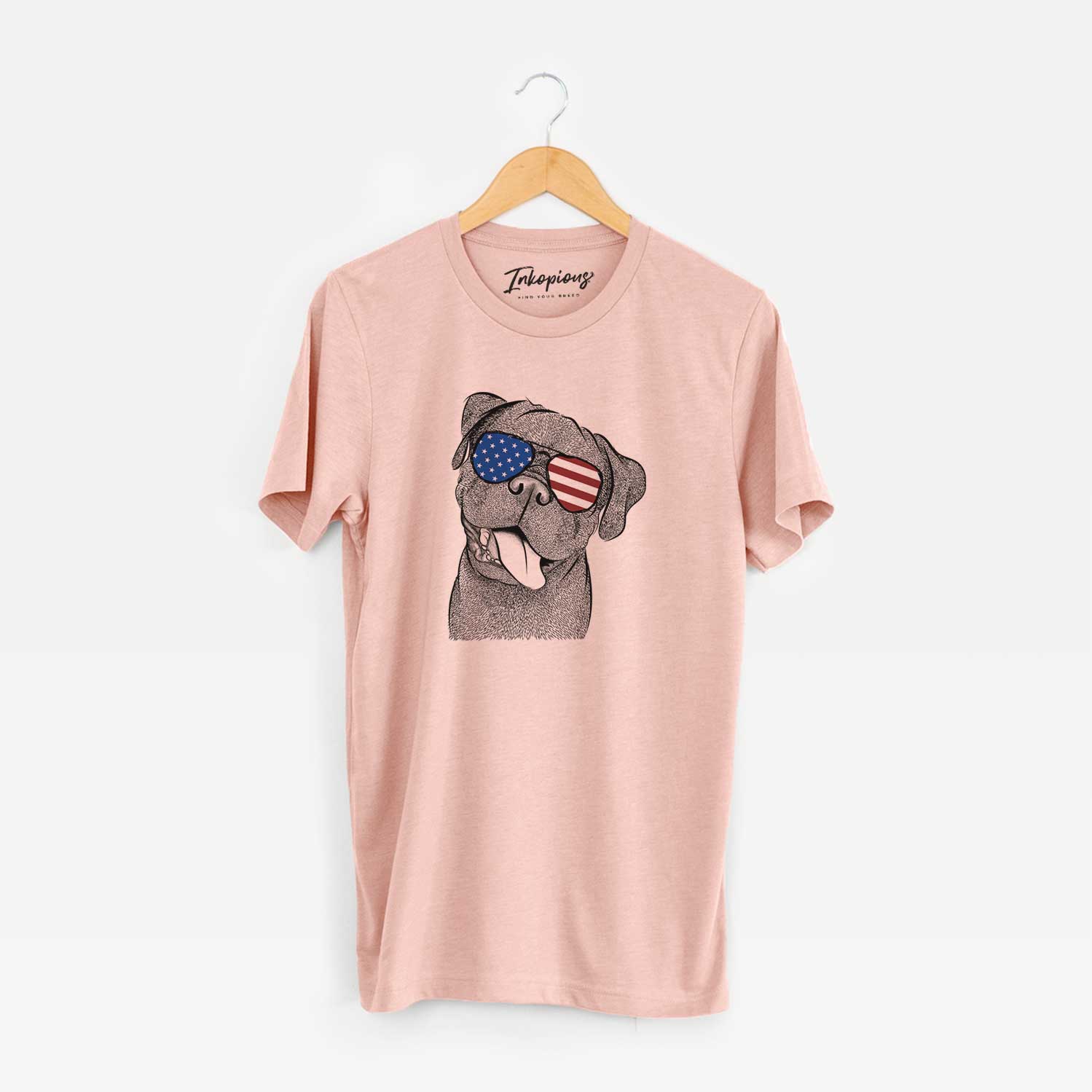 Hand-drawn sketch of Dudley Danger the Pug wearing American flag sunglasses on a Peach Unisex crewneck