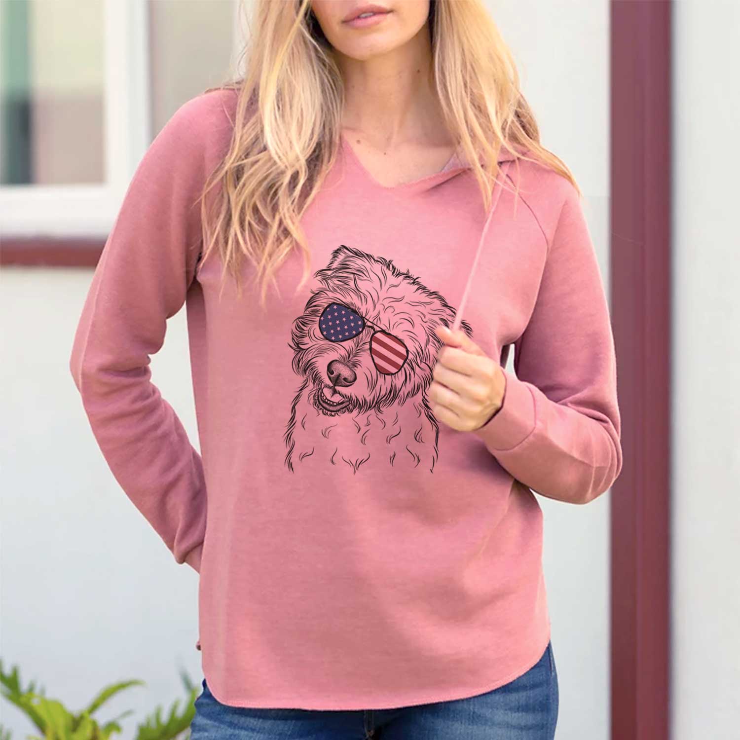 Hand-drawn sketch of Duffy the Glen of Imaal Terrier wearing American flag sunglasses on a Dusty Rose Cali Wave Hooded Sweatshirt, lifestyle photo