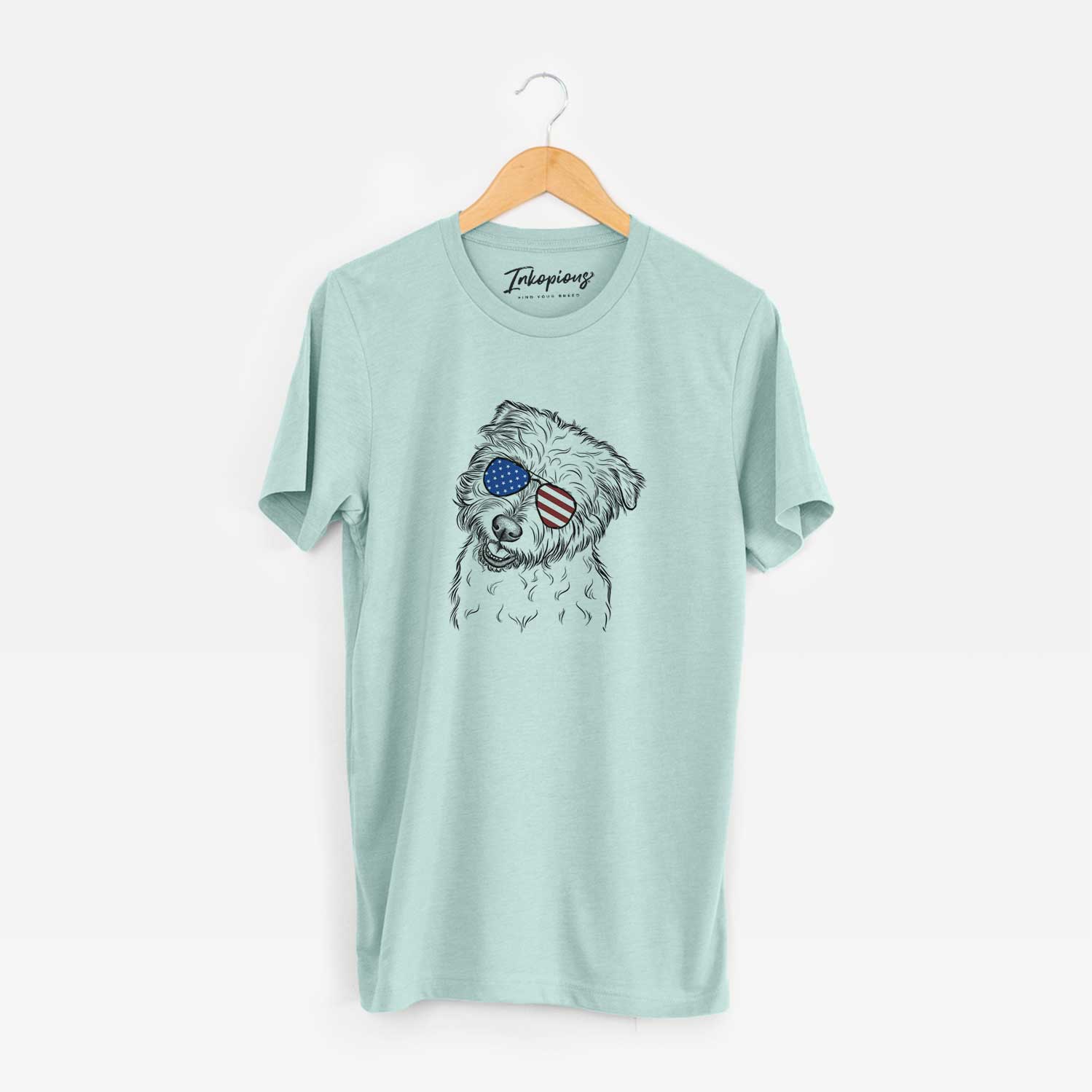 Hand-drawn sketch of Duffy the Glen of Imaal Terrier wearing American flag sunglasses on a Heather Sage Unisex crewneck