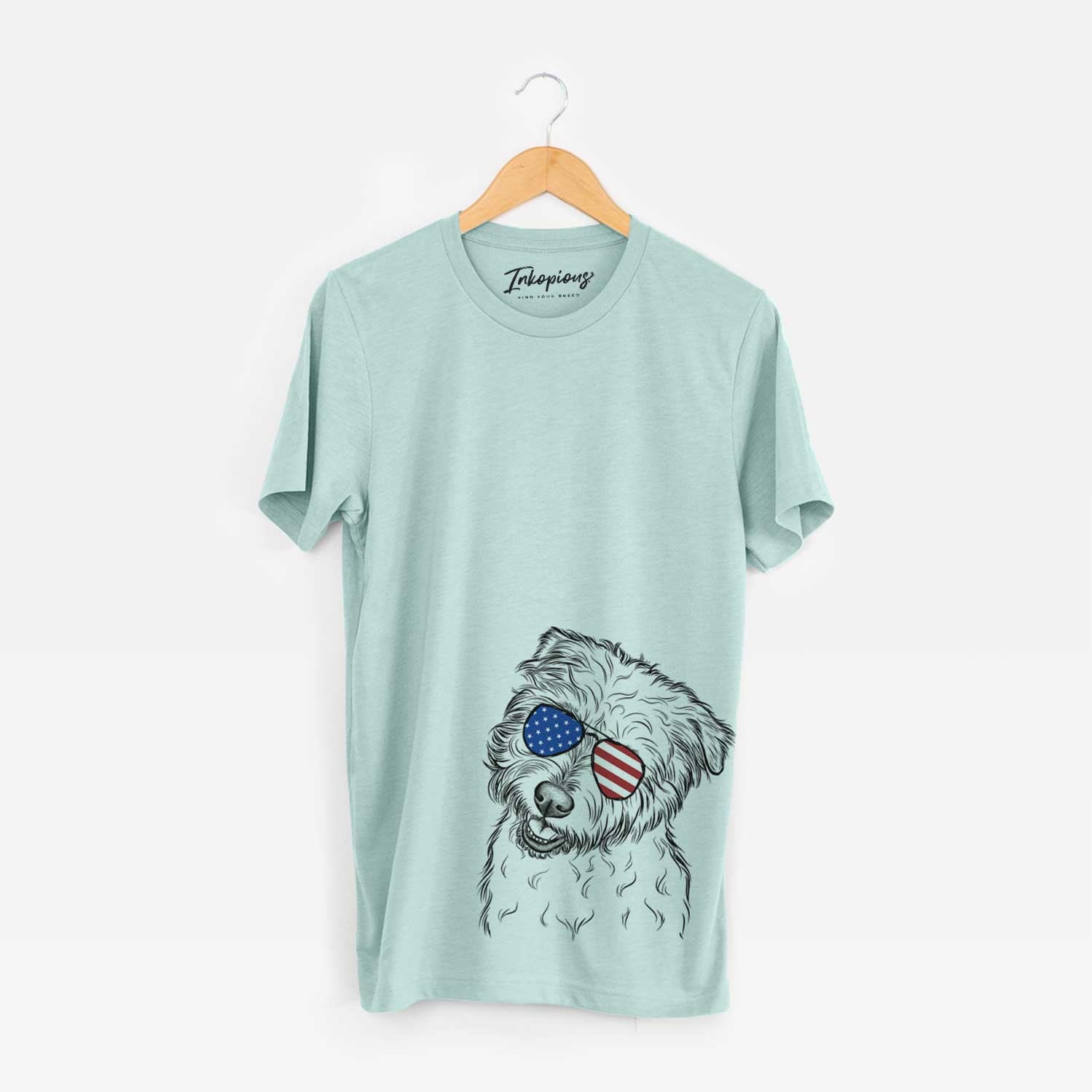 Hand-drawn sketch of Duffy the Glen of Imaal Terrier wearing American flag sunglasses on a Heather Sage Unisex crewneck