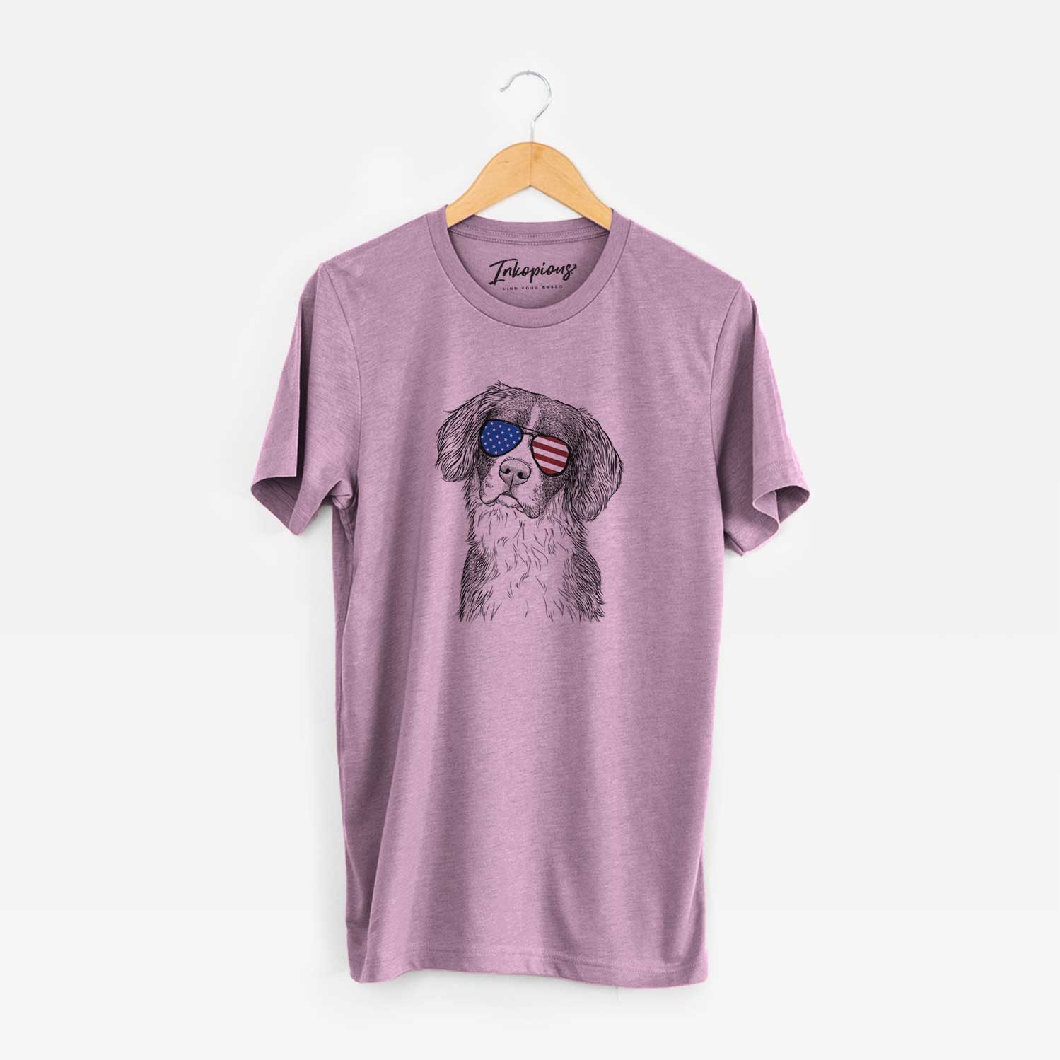 Hand-drawn sketch of Dulce the Drentsche Patrijshond wearing American flag sunglasses on an Orchid Unisex crewneck