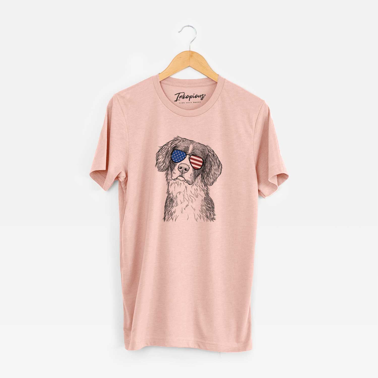 Hand-drawn sketch of Dulce the Drentsche Patrijshond wearing American flag sunglasses on a Peach Unisex crewneck