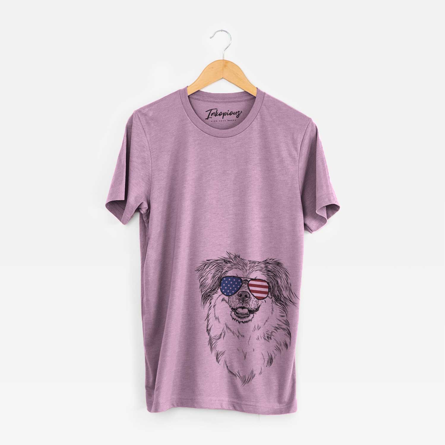 Hand-drawn sketch of Ed the Tibetan Spaniel wearing American flag sunglasses on an Orchid Unisex crewneck