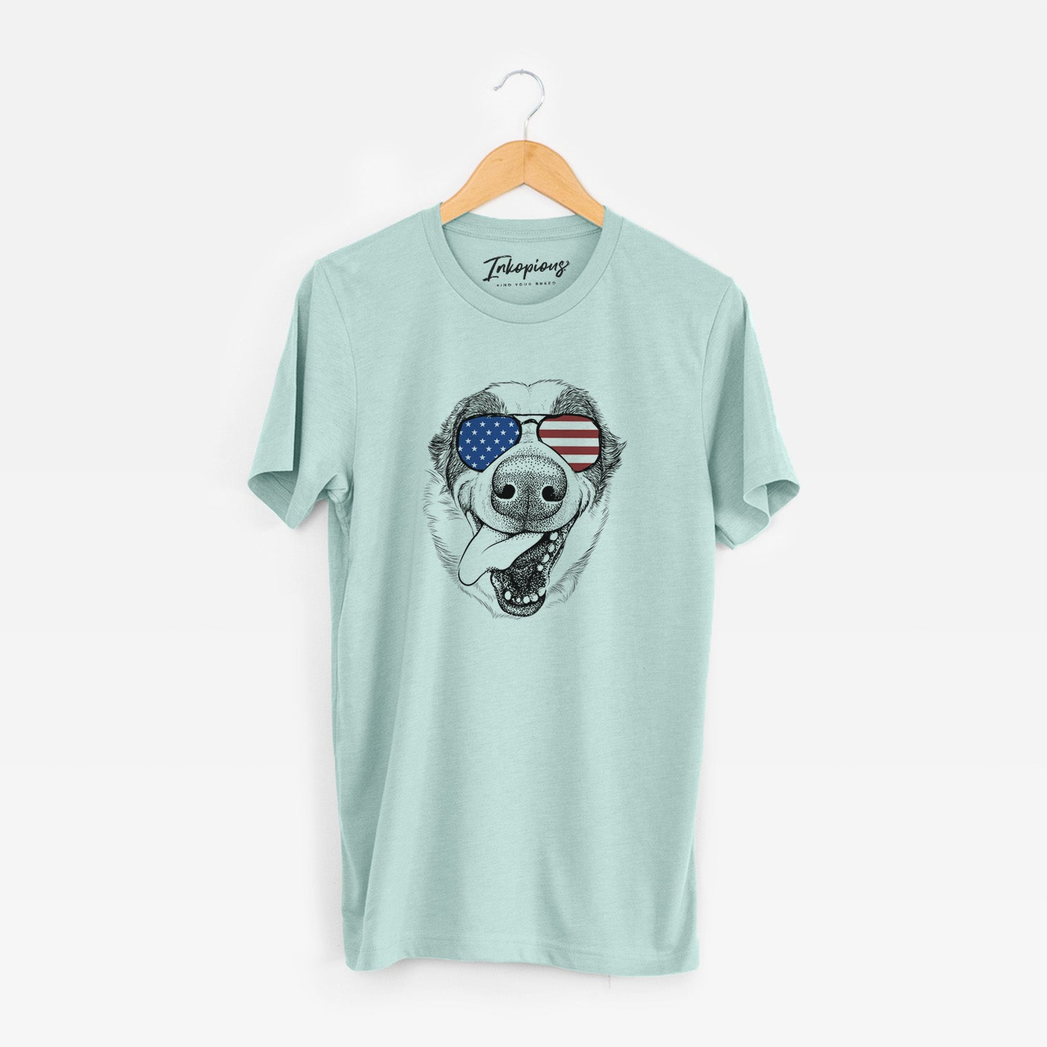 Hand-drawn sketch of Elwood the Border Collie wearing American flag sunglasses on a Heather Sage Unisex crewneck