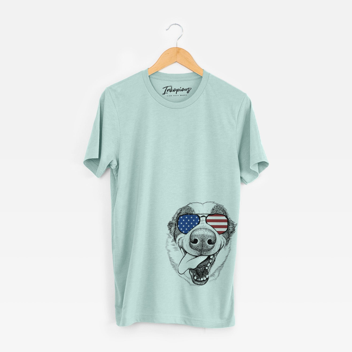 Hand-drawn sketch of Elwood the Border Collie wearing American flag sunglasses on a Heather Sage Unisex crewneck