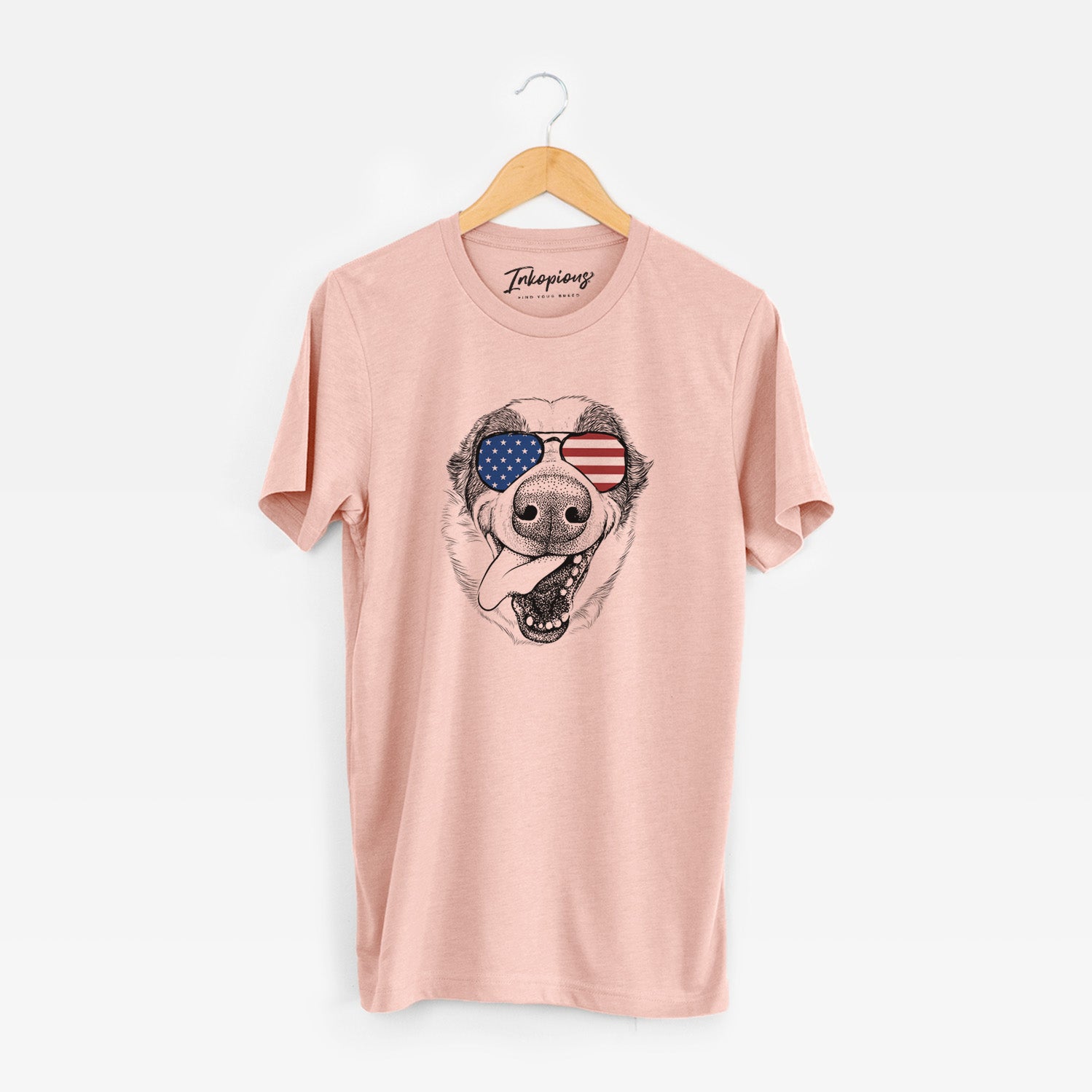 Hand-drawn sketch of Elwood the Border Collie wearing American flag sunglasses on a Peach Unisex crewneck