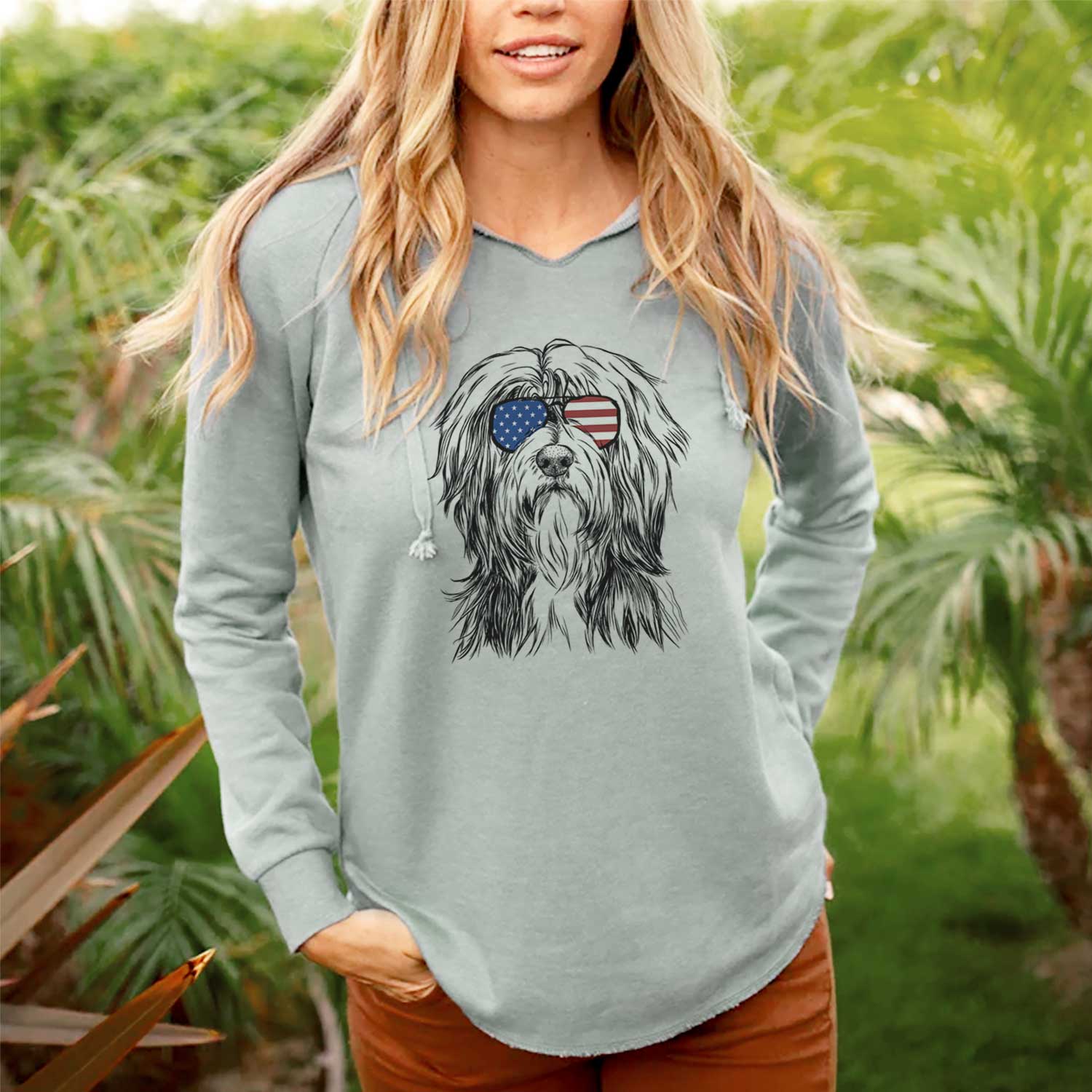 Hand-drawn sketch of Fiji the Polish Lowland Sheepdog wearing American flag sunglasses on a Sage Cali Wave Hooded Sweatshirt, lifestyle photo