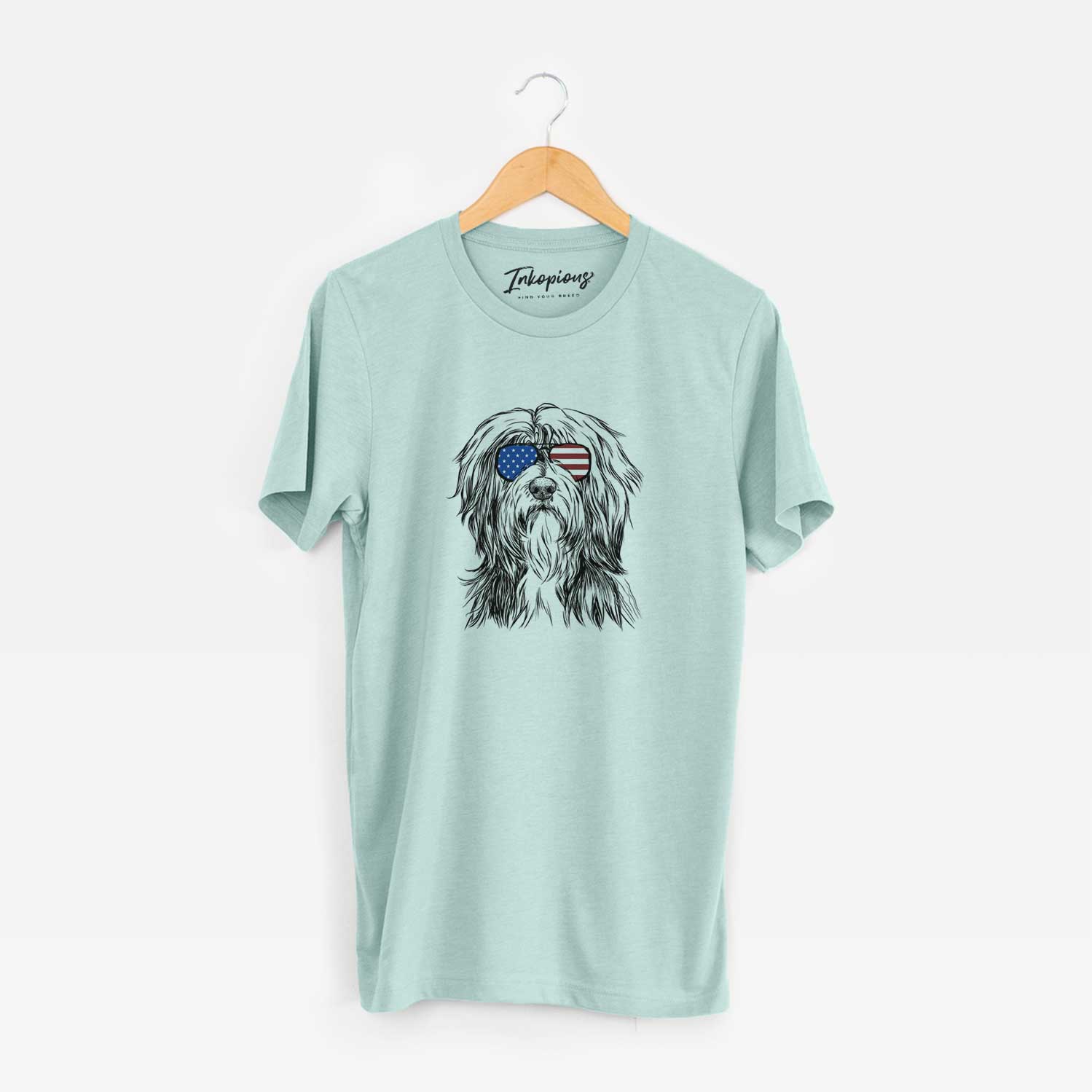 Hand-drawn sketch of Fiji the Polish Lowland Sheepdog wearing American flag sunglasses on a Heather Sage Unisex crewneck